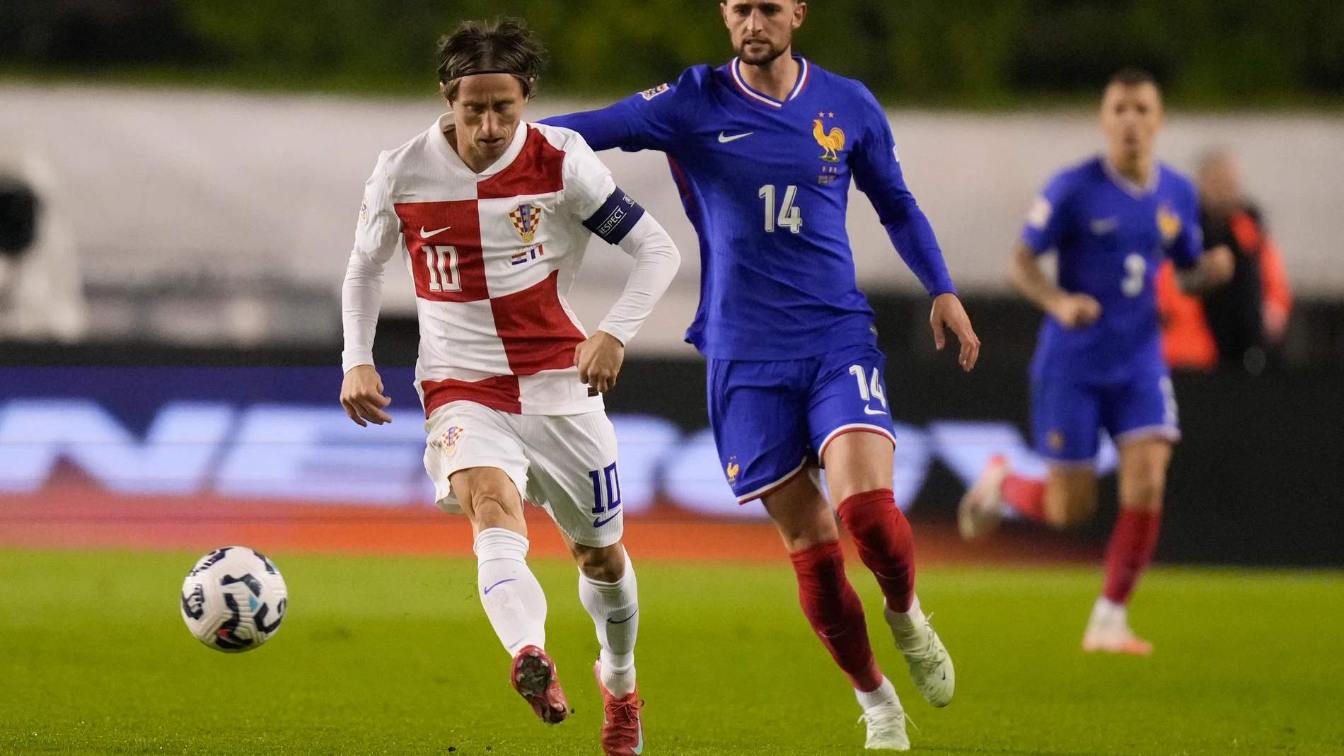Croatia's Luka Modric challenges for the ball with France's Adrien Rabiot during the UEFA Nations League quarterfinal soccer match between Croatia and France, at the Poljud stadium in Split, Croatia, Thursday, March 20, 2025. (AP Photo/Darko Bandic)
