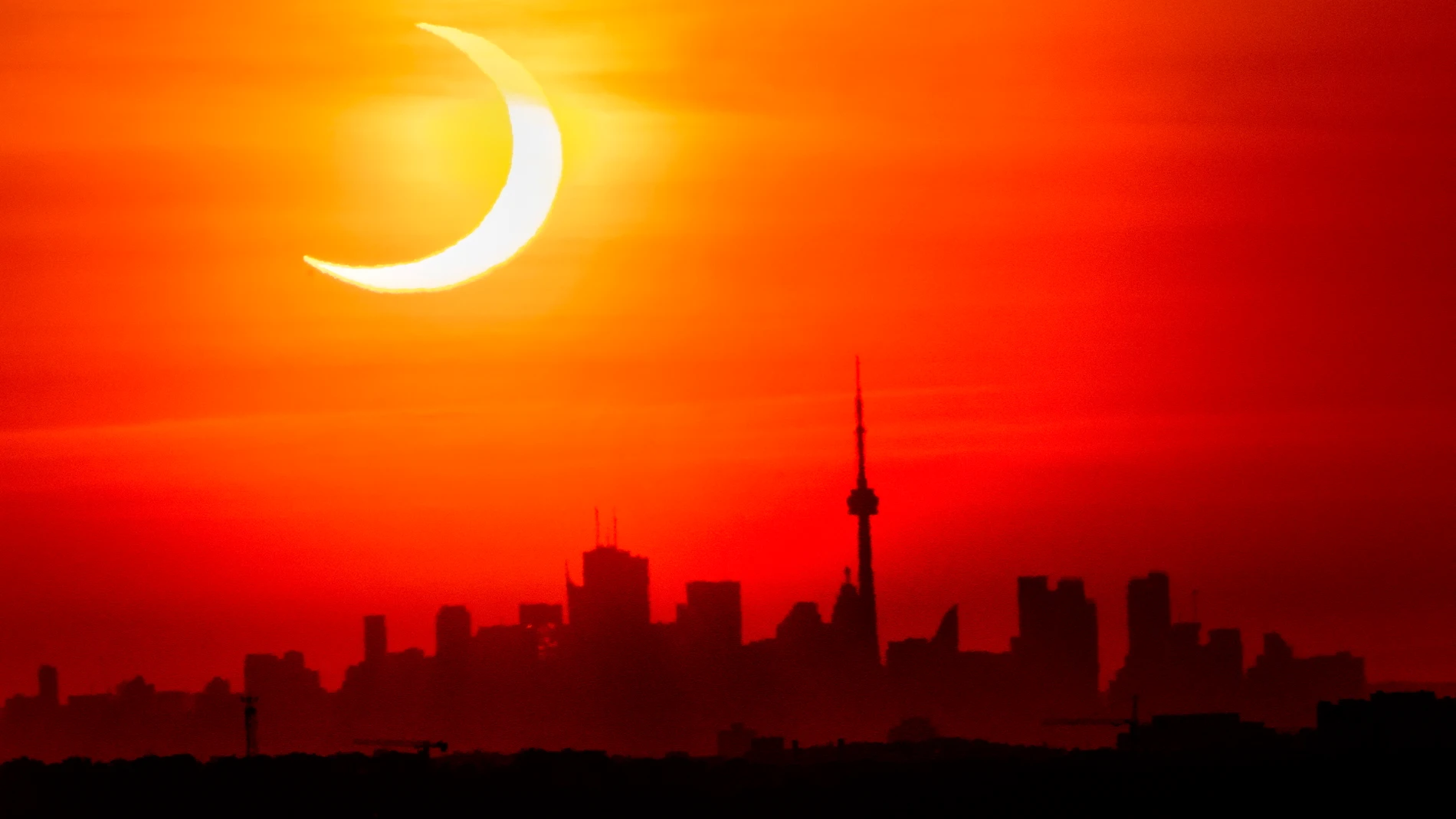FILE - An annular solar eclipse rises over the skyline of Toronto, June 10, 2021. (Frank Gunn/The Canadian Press via AP, File)