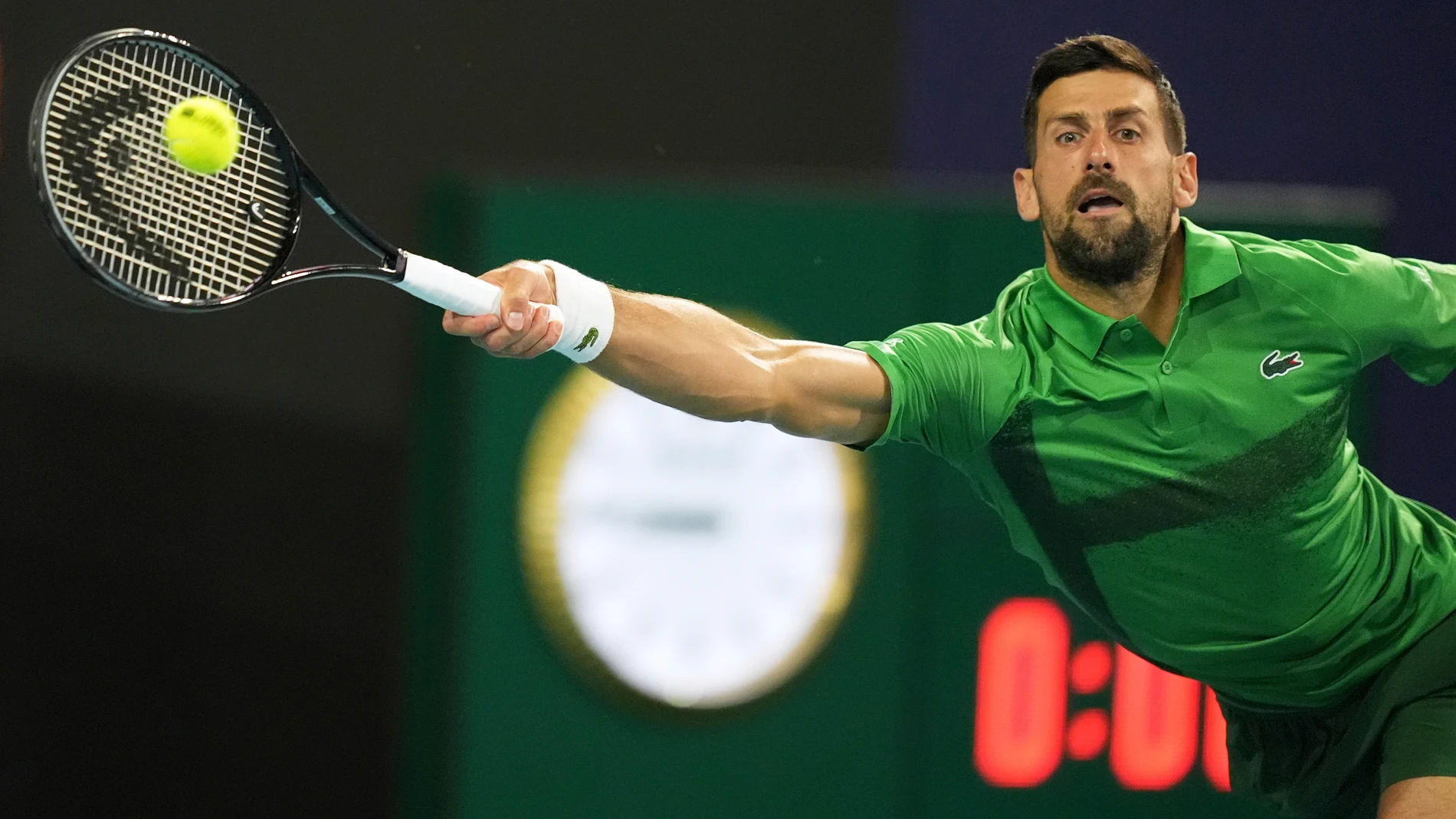Novak Djokovic, of Serbia, plays a shot to Jakub Mensik, of Czech Repbulic, in the men's singles final match at the Miami Open tennis tournament, Sunday, March 30, 2025, in Miami Gardens, Fla. (AP Photo/Rebecca Blackwell)