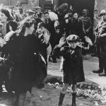 This Feb. 17, 1941 file photo shows a scene in the Warsaw Ghetto where Jews wearing white armlets bearing the Star of David board a tram marked with the words.