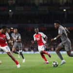 Vinicius, rodeado de rivales durante el partido en el Emirates Stadium