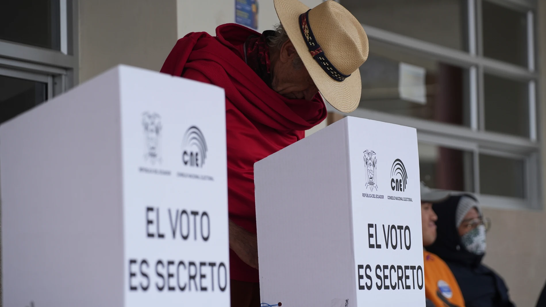A voter marks his ballot during a presidential election runoff in Quito, Ecuador, Sunday, April 13, 2025. (AP Photo/Carlos Noriega)