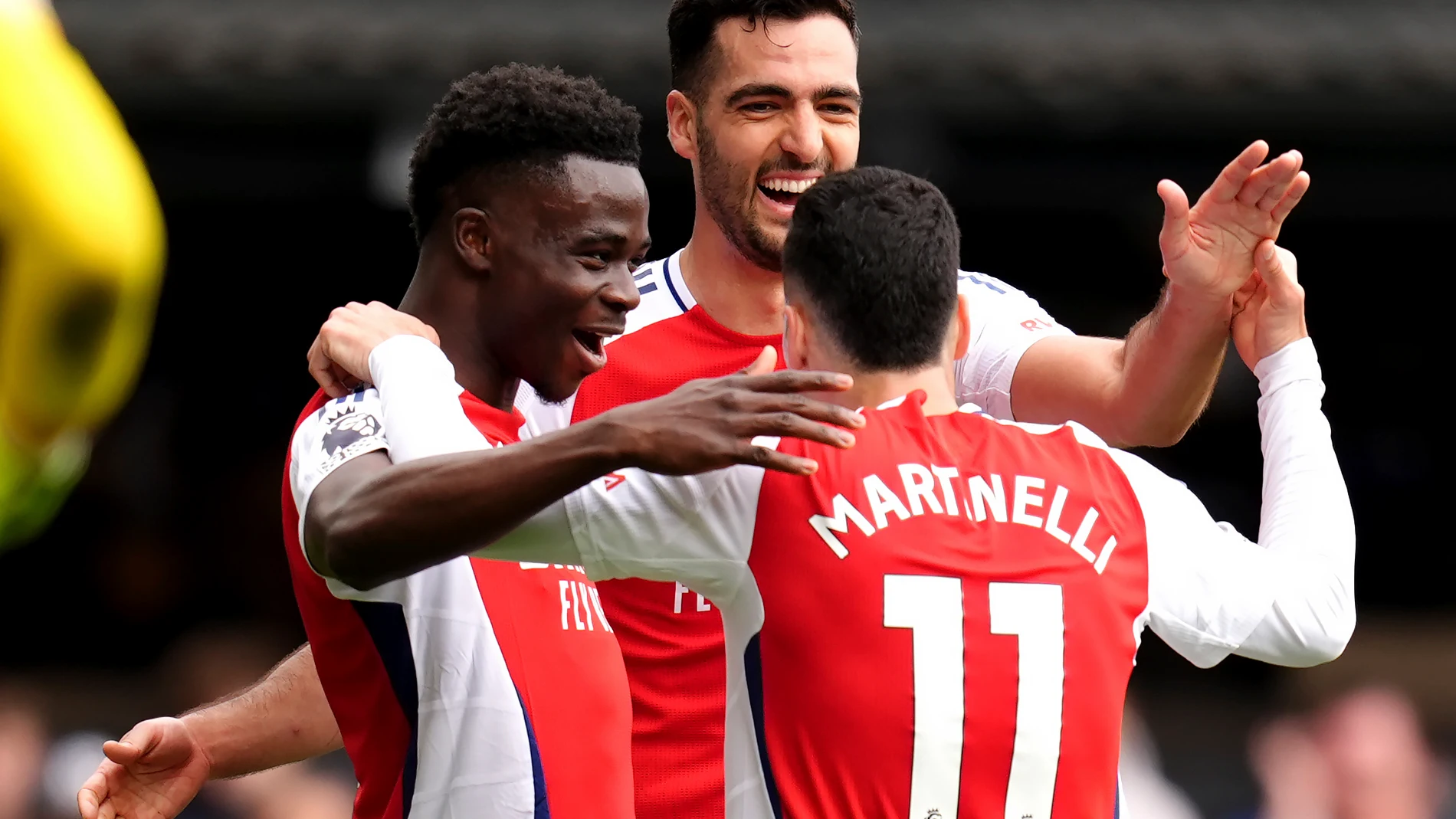 Arsenal's Gabriel Martinelli, right, celebrates scoring their side's second goal of the game during the English Premier League soccer match between Ipswich Town and Arsenal at Portman Road, Ipswich, England, Sunday, April 20, 2025. (John Walton/PA via AP)