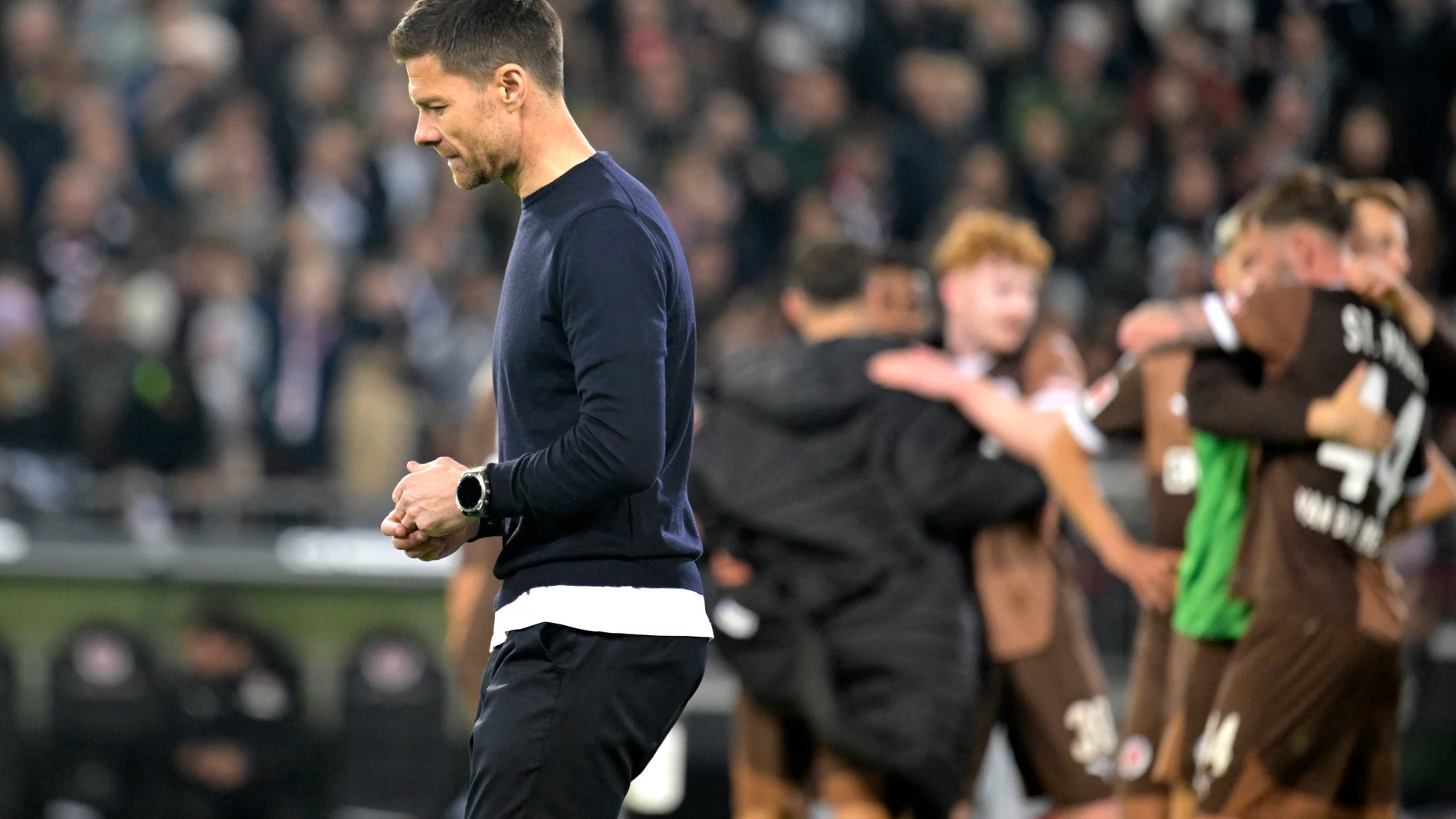 HAMBURG (Germany), 20/04/2025.- Leverkusen’s head coach Xabi Alonso leaves the pitch while St. Pauli’s players celebrate after the German Bundesliga soccer match between FC St. Pauli and Bayer Leverkusen at Millerntor Stadium in Hamburg, Germany, 20 April 2025. (Alemania, Hamburgo) EFE/EPA/FABIAN BIMMER CONDITIONS - ATTENTION: The DFL regulations prohibit any use of photographs as image sequences and/or quasi-video.