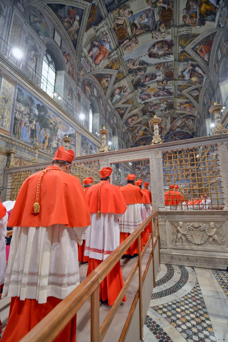 In this picture released by the Vatican newspaper L'Osservatore Romano, Cardinals enter the Sistine Chapel at the Vatican, Tuesday, March 12, 2013, to start the conclave to elect the 266th Roman Catholic pope. Cardinals from around the globe locked themselves inside the Sistine Chapel on Tuesday to choose a new leader for the world's 1.2 billion Catholics and their troubled church, surrounded by Michelangelo's imposing frescos imagining the beginning and the end of the world.