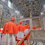 In this picture released by the Vatican newspaper L'Osservatore Romano, Cardinals enter the Sistine Chapel at the Vatican, Tuesday, March 12, 2013, to start the conclave to elect the 266th Roman Catholic pope. Cardinals from around the globe locked themselves inside the Sistine Chapel on Tuesday to choose a new leader for the world's 1.2 billion Catholics and their troubled church, surrounded by Michelangelo's imposing frescos imagining the beginning and the end of the world. 