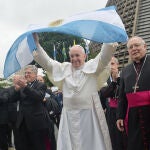 Pope Francis holds up an Argentine flag outside the Metropolitan Cathedral in Rio de Janeiro, Brazil, July 25, 2013.