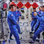 An image captured at the Beijing Aerospace Control Center shows the crews of China's Shenzhou-19 and Shenzhou-20 manned missions communicating with each other on the Tiangong Space Station, 25 April 2025. 