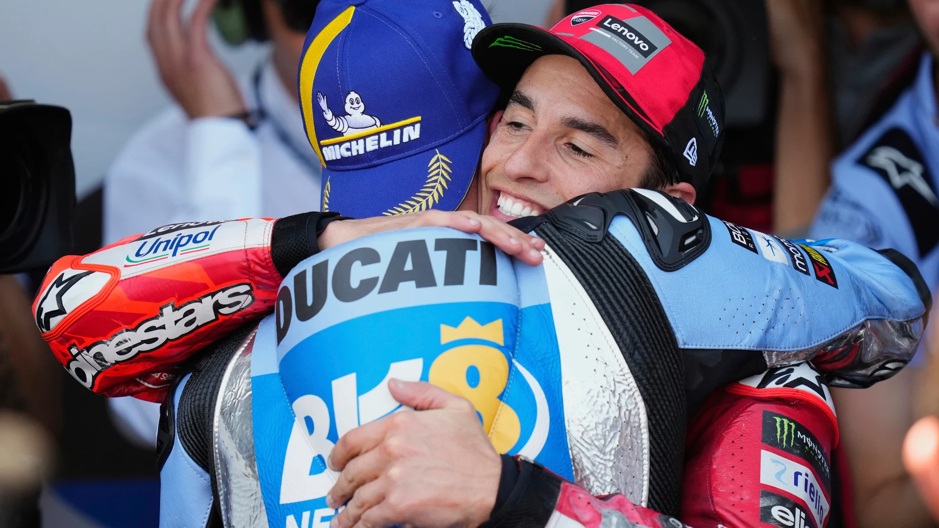 Race winner Spain's rider Alex Marquez of the BK8 Gresini Racing MotoGP, front, hugs his brother Spain's rider Marc Marquez of the Ducati Lenovo Team after the MotoGP race of the Grand Prix of Spain, at the Angel Nieto racetrack in Jerez de la Frontera, Spain, Sunday, April 27, 2025. (AP Photo/Jose Breton)