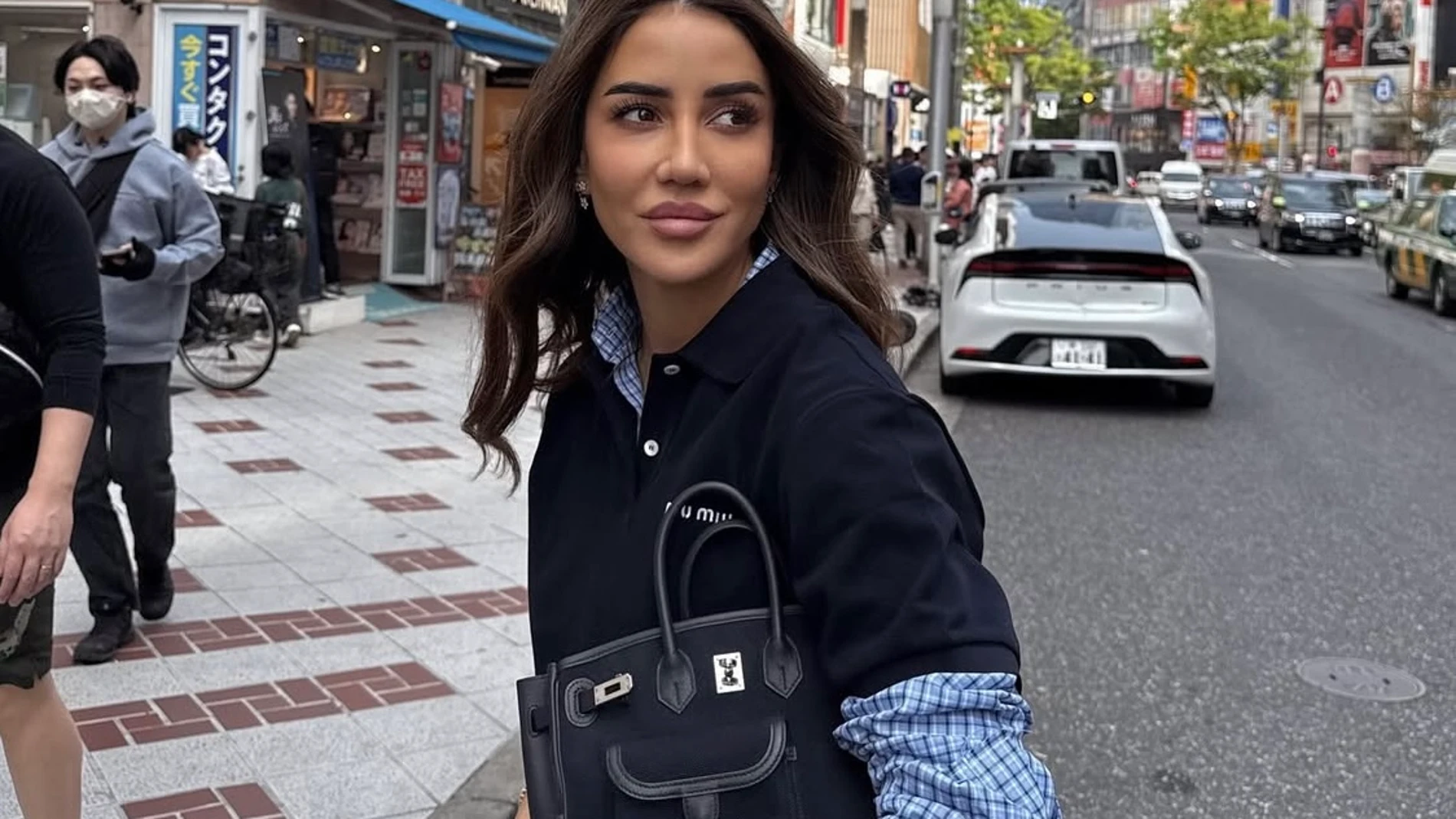 Influencer con bolso azul marino.