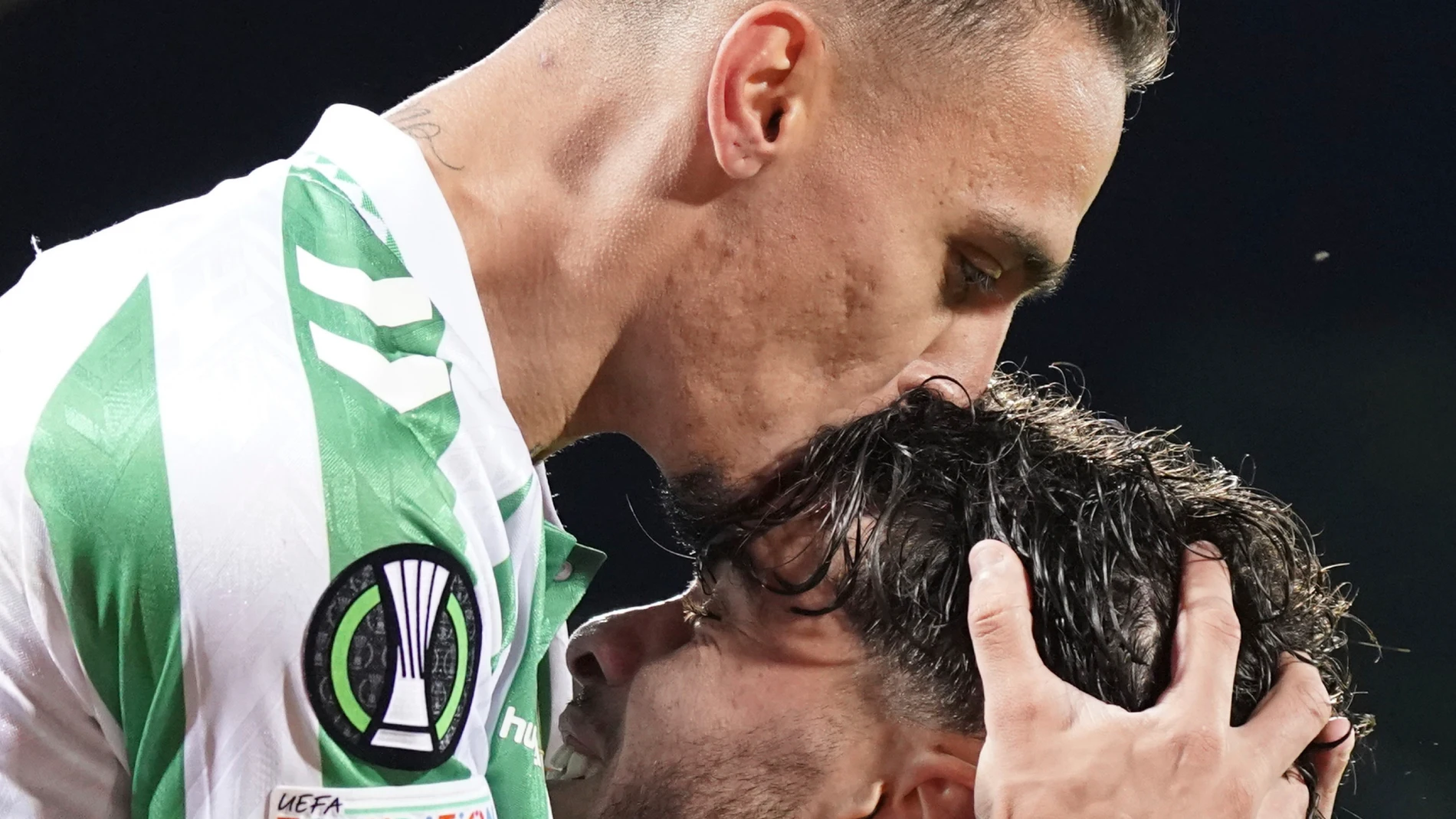 Betis' Abdessamad Ezzalzuoli celebrates with Antony, top, after scoring their second goal of the game during the UEFA Conference League second leg semifinal soccer match between Fiorentina and Real Betis at Artemio Franchi stadium in Florence, Italy, Thursday, May 8, 2025. (Marco Bucco/LaPresse via AP)