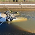 Bomberos rescatando el coche hundido en un canal de Cartaya