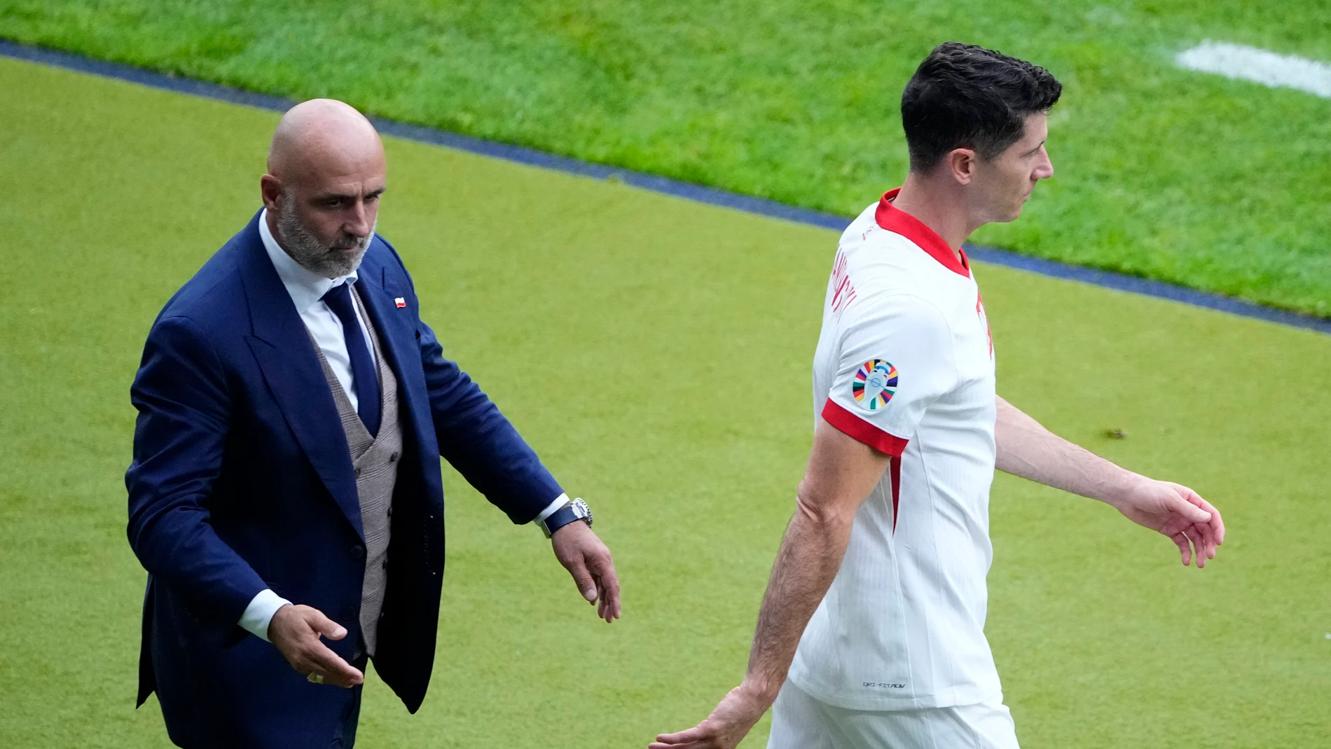 FILE - Poland's Robert Lewandowski, right, walks by Poland' head coach Michal Probierz, left, during a Group D match between Poland and Austria at the Euro 2024 soccer tournament in Berlin, Germany, Friday, June 21, 2024. (AP Photo/Petr Josek, File)