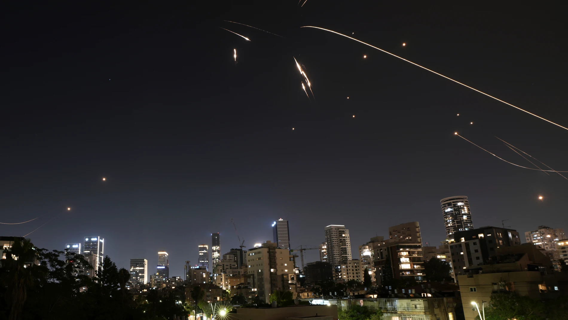 Israel's air defense system fire to intercepts projectiles launched from Iran, as seen in Ramat Gan, near Tel Aviv, Israel on Friday, June 13, 2025. (AP Photo/Oded Balilty)