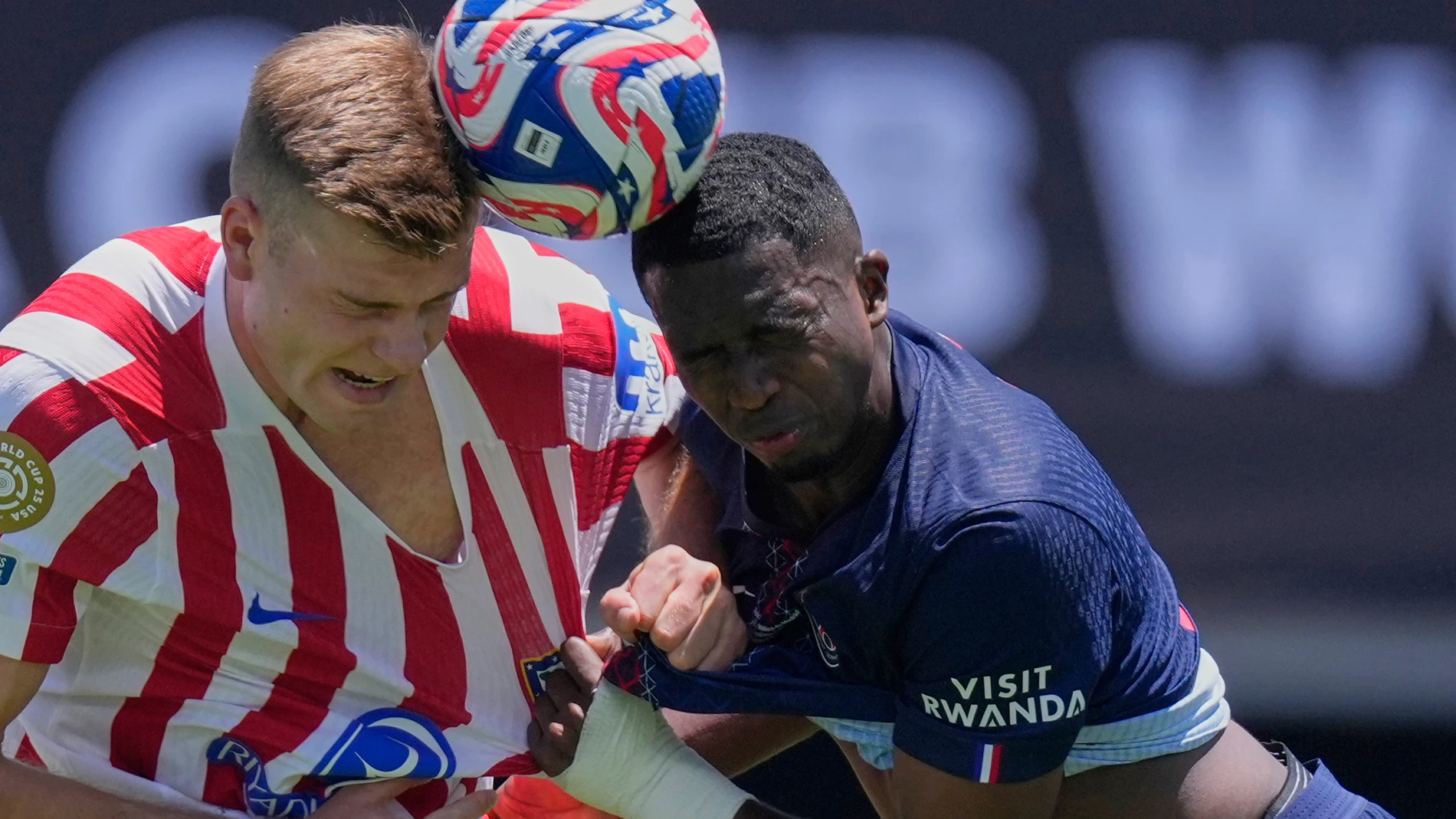 Atletico Madrid's Alexander Sorloth, left, goes for a header with Paris Saint-Germain's Willian Pacho during the Club World Cup group B soccer match between PSG and Atletico Madrid, in Pasadena, Calif., Sunday, June 15, 2025. (AP Photo/Mark J. Terrill)