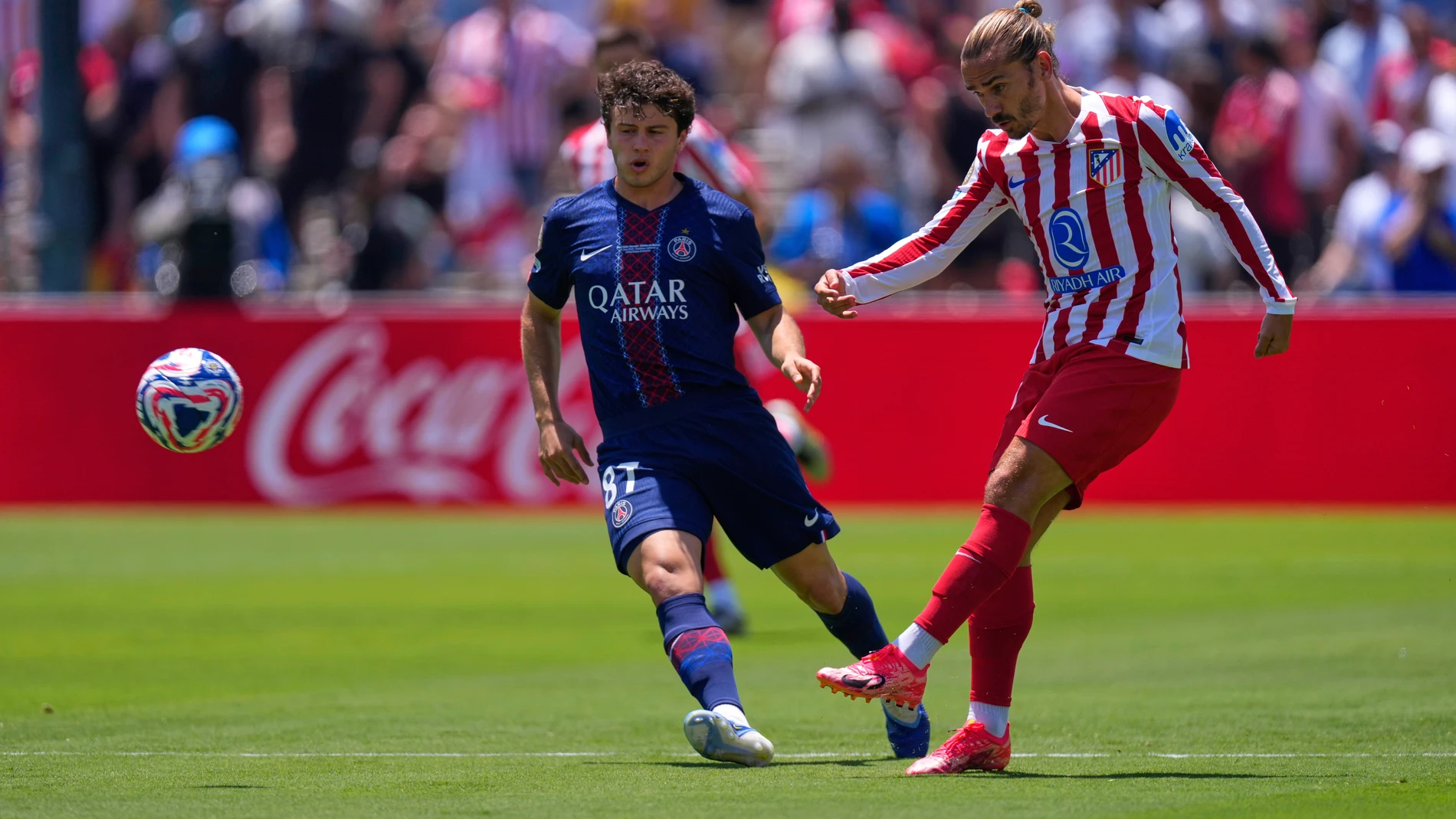 Atletico Madrid's Antoine Griezmann, right, shoots the ball next to Paris Saint-Germain's Joao Neves during the Club World Cup group B soccer match between PSG and Atletico Madrid, in Pasadena, Calif., Sunday, June 15, 2025. (AP Photo/Mark J. Terrill)