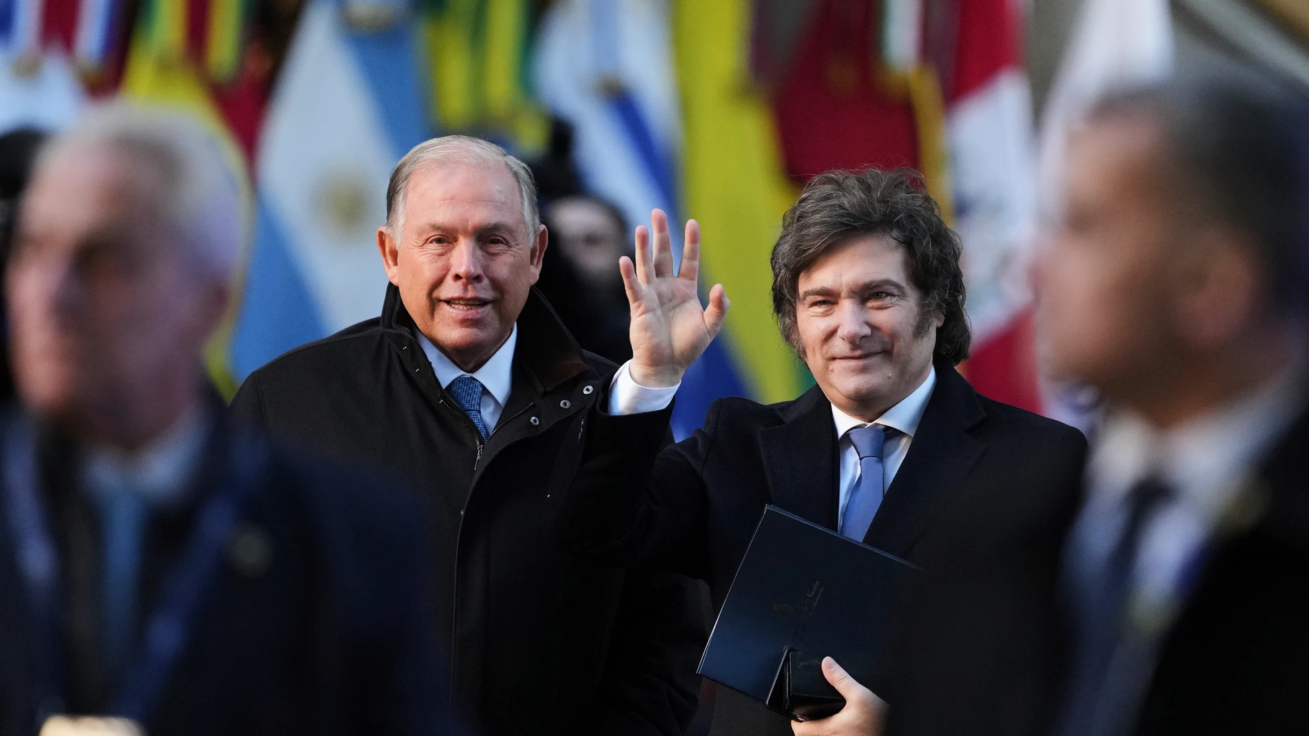 Argentine President Javier Milei waves to the press next to his Foreign Minister Gerardo Werthein at the Mercosur Summit in Buenos Aires, Argentina, Thursday, July 3, 2025. (AP Photo/Natacha Pisarenko)