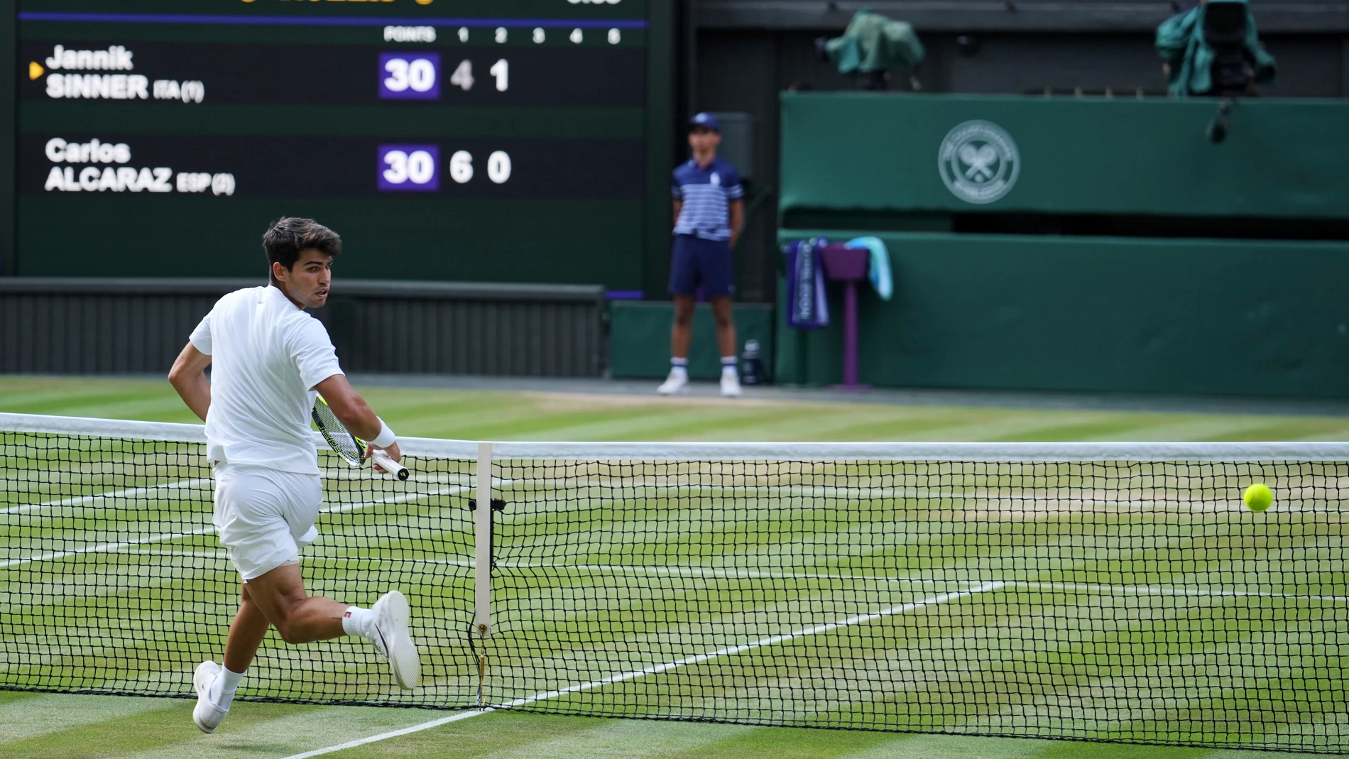 Carlos Alcaraz of Spain looks around as a passing shot goes past him as he plays Italy's Jannik Sinner in the men's singles final at the Wimbledon Tennis Championships in London, Sunday, July 13, 2025. (AP Photo/Kin Cheung)