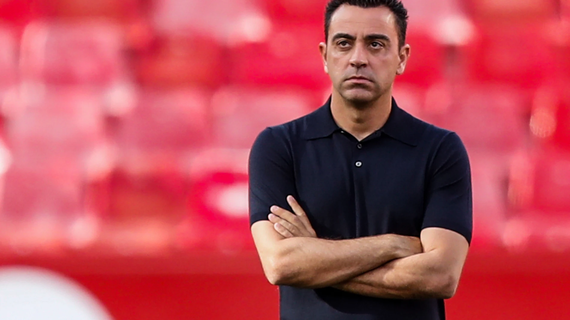 FILE - Barcelona's head coach Xavi Hernandez watches before the Spanish La Liga soccer match between Sevilla and FC Barcelona at the Ramon Sanchez Pizjuan stadium in Seville, Spain, Sunday, May 26, 2024. (AP Photo/Fermin Rodriguez, File)
