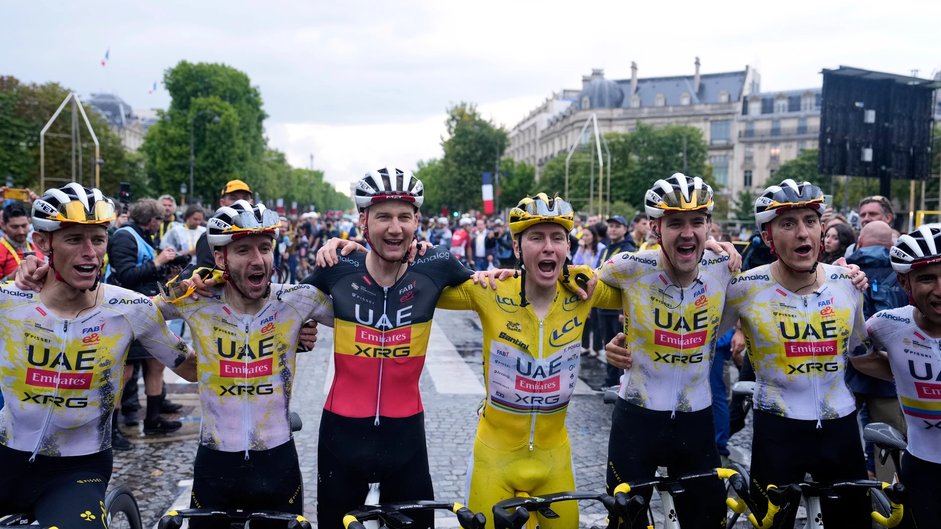 Tour de France winner Tadej Pogacar of Slovenia and teammates from left, Germany's Nils Politt, Britain's Adam Yates, Belgium's Tim Wellens, France's Pavel Sivakov, Belgium's Tim Wellens and Ecuador's Jhonatan Narvaez, celebrate after the twenty-first stage of the Tour de France cycling race over 132.3 kilometers (82.1 miles) with start in Mantes-la-Ville and finish on the Champs-Elysees in Paris, France, Sunday, July 27, 2025. (AP Photo/Mosa'ab Elshamy)