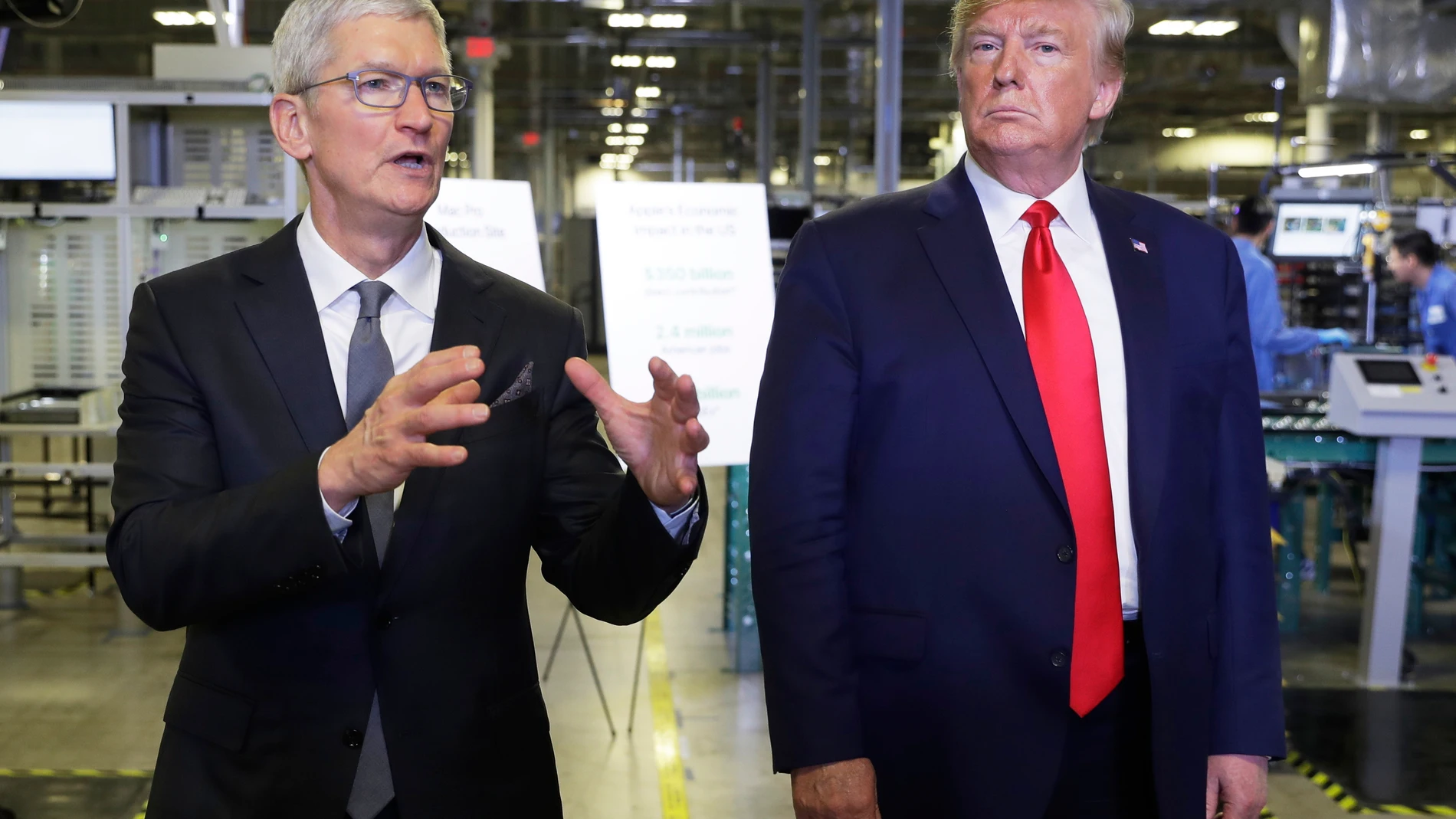 FILE - Apple CEO Tim Cook and President Donald Trump speak during a tour of an Apple manufacturing plant, Nov. 20, 2019, in Austin. (AP Photo/ Evan Vucci, FIle)