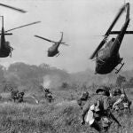 In this March 1965 file photo shot by Associated Press photographer Horst Faas, hovering U.S. Army helicopters pour machine gun fire into the tree line to cover the advance of South Vietnamese ground troops in an attack on a Viet Cong camp 18 miles north of Tay Ninh, Vietnam, northwest of Saigon near the Cambodian border.