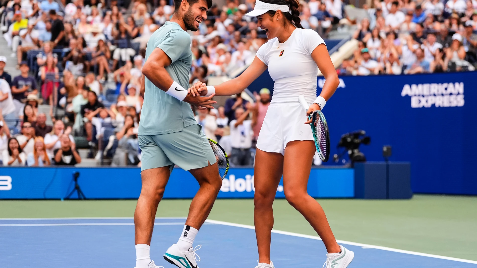 Carlos Alcaraz, left, of Spain, and Emma Raducanu, of Great Britain, celebrate during their mixed doubles match at the U.S. Open tennis championships, Tuesday, Aug. 19, 2025, in New York. (AP Photo/Yuki Iwamura)