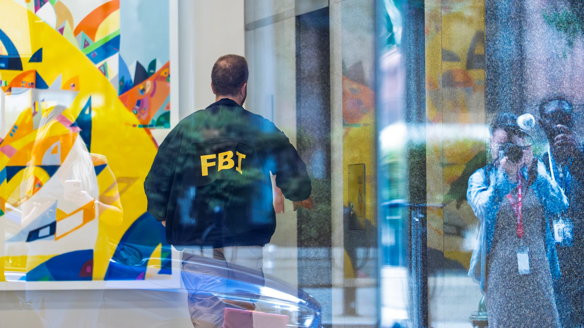 An FBI agent arrives in the lobby of the office building of former national security adviser John Bolton, Friday, August 22, 2025, in Washington. (AP Photo/J. Scott Applewhite)
