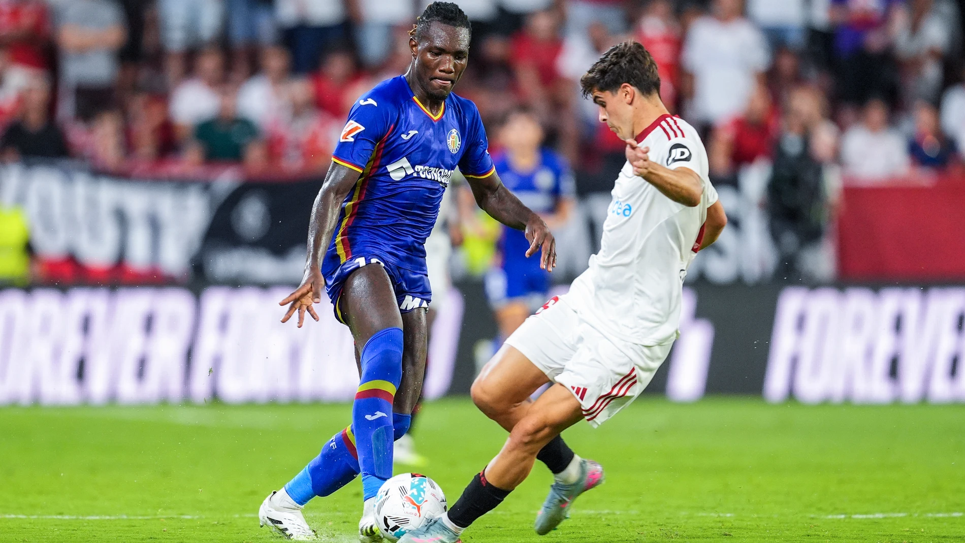 Christantus Uche of Getafe CF and Juanlu Sanchez of Sevilla FC in action during the Spanish league, LaLiga EA Sports, football match played between Sevilla FC and Getafe CF at Ramon Sanchez-Pizjuan stadium on August 25, 2025, in Sevilla, Spain. AFP7 25/08/2025 ONLY FOR USE IN SPAIN