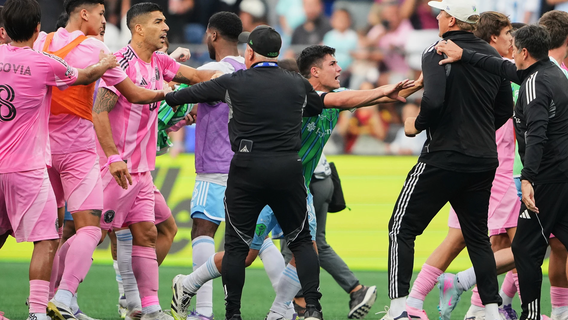 Inter Miami forward Luis Suárez, third from left, is separated from Seattle Sounders players and staff as Sounders midfielder Kalani Kossa-Rienzi, center right facing, holds a staff member back during a fight after the Sounders won the Leagues Cup final soccer match Sunday, Aug. 31, 2025, in Seattle. (AP Photo/Lindsey Wasson)