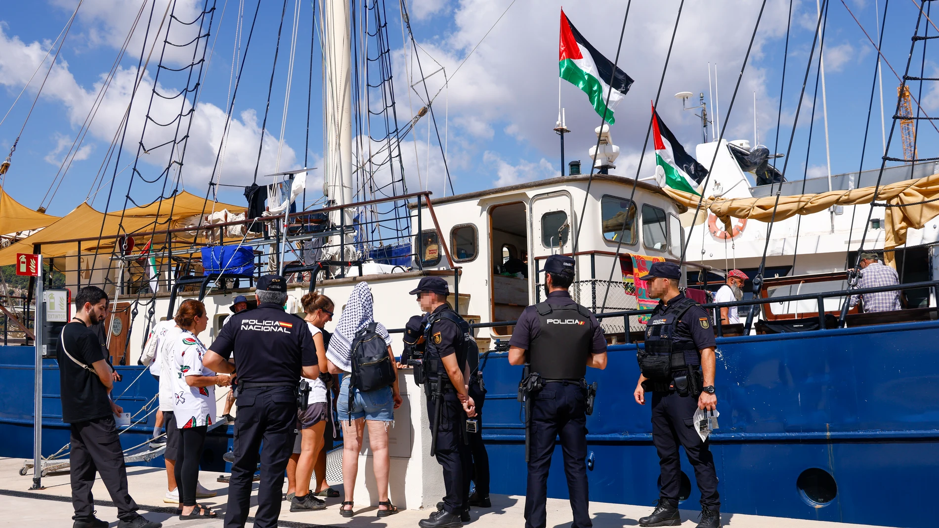 GRAFCAT1489. BARCELONA (ESPAÑA), 01/09/2025.- La veintena de barcos de la Global Sumud Flotilla o flotilla de la libertad que zarparon ayer domingo del Puerto de Barcelona hacia Gaza con ayuda humanitaria han regresado esta madrugada por el mal tiempo y sus capitanes se encuentran reunidos este lunes para decidir cuándo volver a partir. En la imagen, ageentes del CNP realizan un control ante uno de los barcos amarrado en el muelle de la Marina del Puerto de Barcelona.EFE/ Quique García