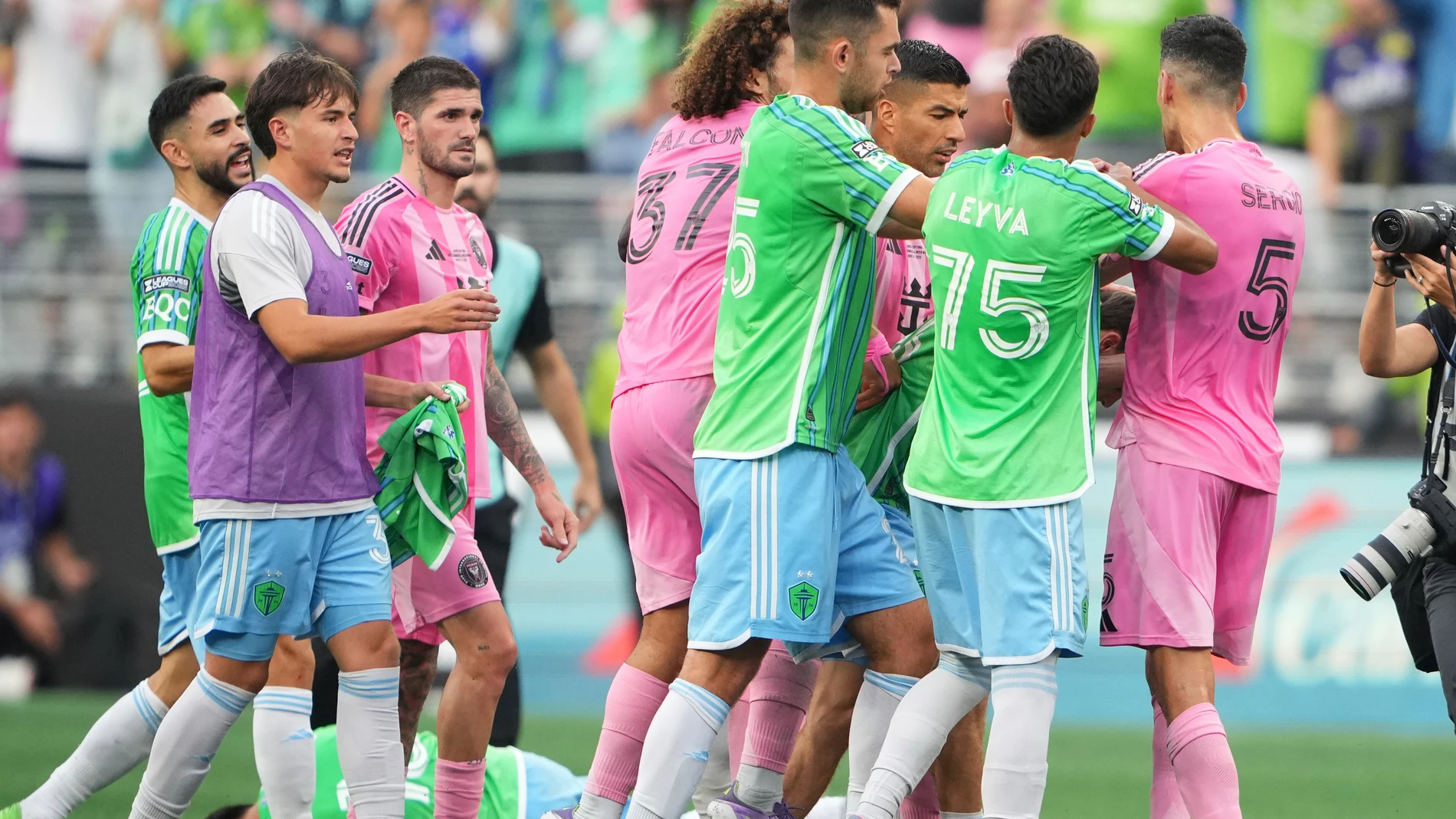 Seattle Sounders midfielder Obed Vargas, bottom left, lies on the ground after being pushed during an altercation against Inter Miami, including forward Luis Suárez and midfielder Sergio Busquets (5) after the Sounders won a Leagues Cup final soccer match Sunday, Aug. 31, 2025, in Seattle. (AP Photo/Lindsey Wasson)