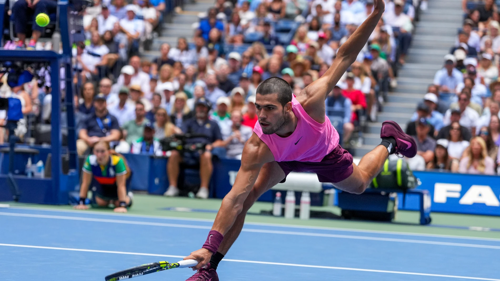 Carlos Alcaraz, of Spain, returns a shot to Jiri Lehecka, of the Czech Republic, during the quarterfinal round of the U.S. Open tennis championships, Tuesday, Sept. 2, 2025, in New York. (AP Photo/Kirsty Wigglesworth)