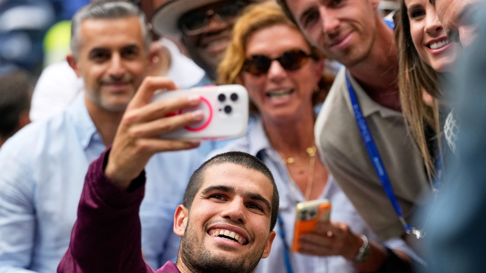 Carlos Alcaraz, of Spain, takes a seflie after defeating Novak Djokovic, of Serbia, during the men's singles semifinals of the U.S. Open tennis championships, Friday, Sept. 5, 2025, in New York. (AP Photo/Seth Wenig)