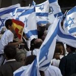 Un niño enarbola una bandera de España entre enseñas de Israel
