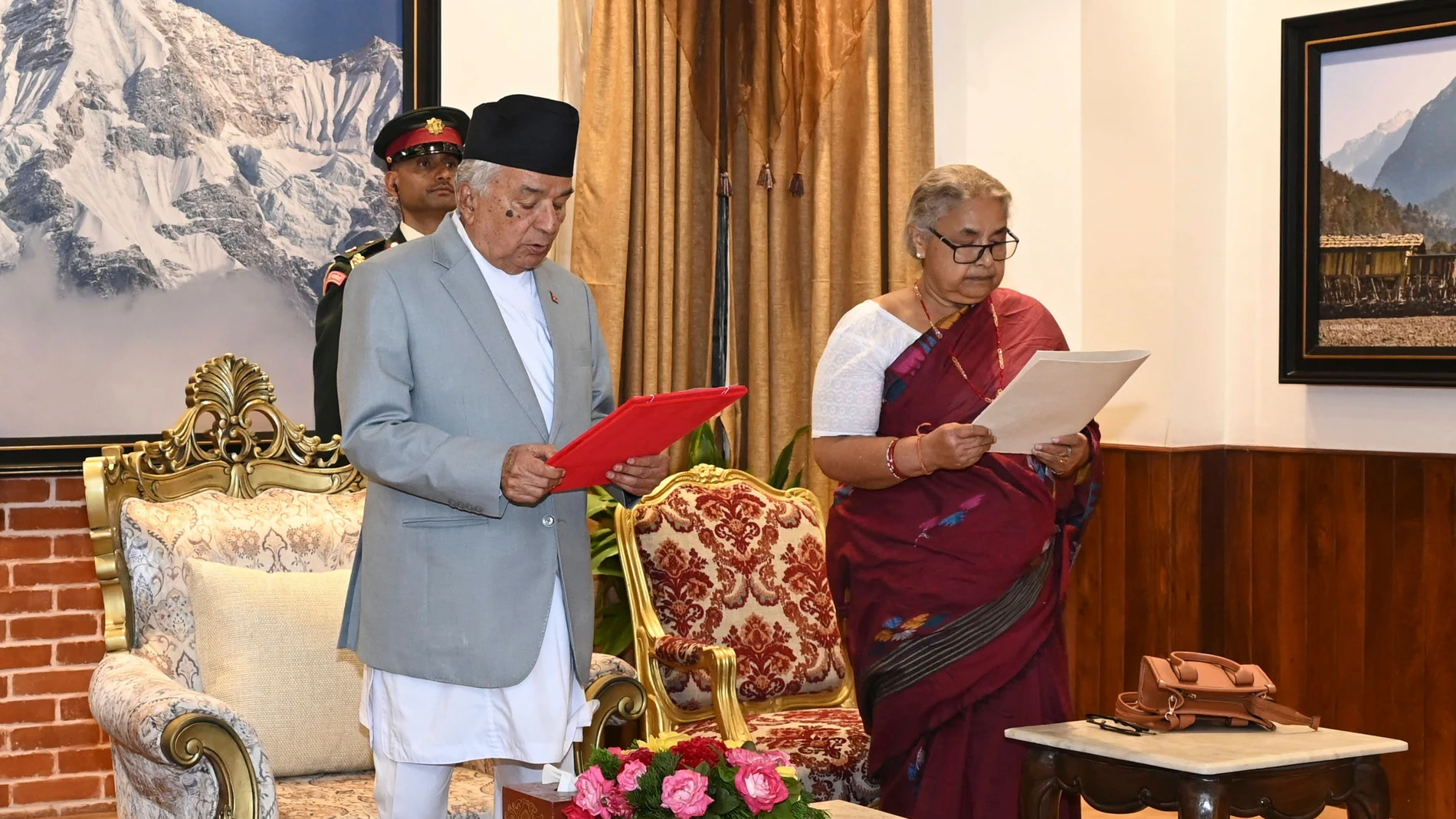 In this photo provided by the Nepalese President House, former Supreme Court Chief Justice Sushila Karki, right, is administered the oath of office by Nepalese President Ram Chandra Poudel, center, in Kathmandu, Nepal, Friday, Sept. 12, 2025, following protests that collapsed the previous administration. (Nepalese President House via AP)