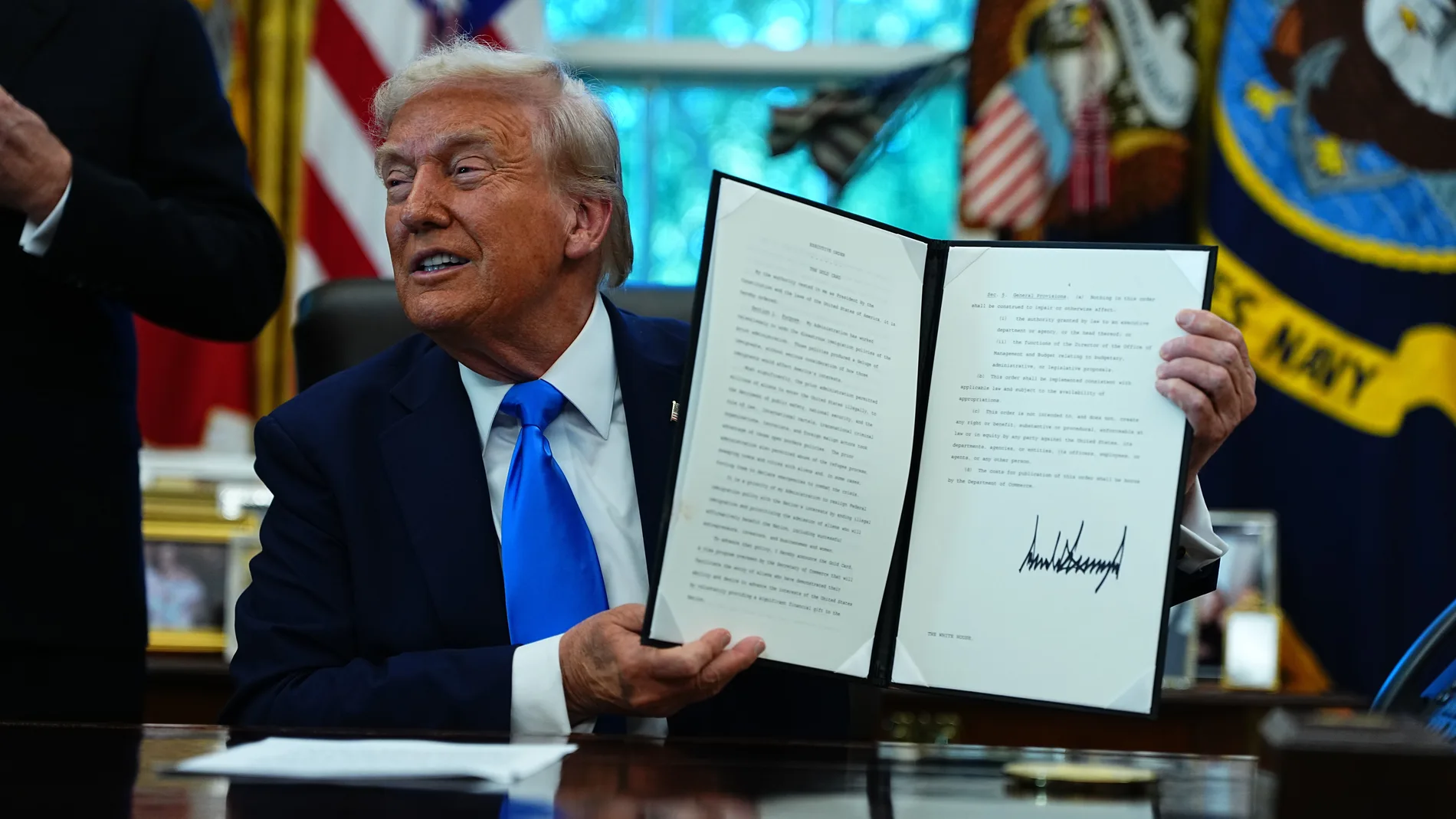September 19, 2025, Washington, District Of Columbia, USA: United States President Donald J Trump holds a signed Executive Order authorizing the new Trump Gold Card, which is a visa program to be overseen by the Secretary of Commerce 'that will facilitate the entry of aliens who have demonstrated their ability and desire to advance the interests of the United States by voluntarily providing a significant financial gift to the nation' in the Oval Office of the White House in Washington, DC, US...
