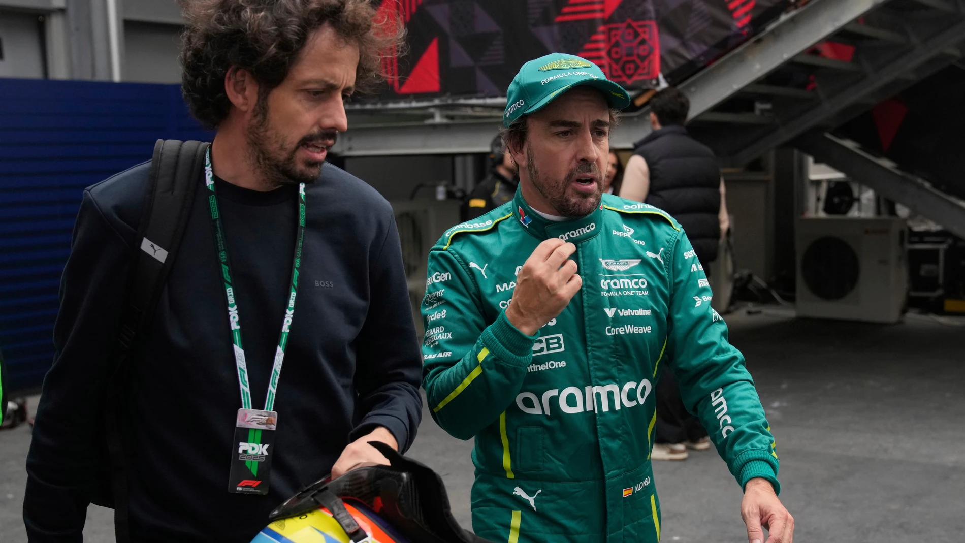 Aston Martin driver Fernando Alonso of Spain walks in the pit lane during the qualifying for the Azerbaijan Formula One Grand Prix in Baku, Azerbaijan, Saturday, Sept. 20, 2025. (AP Photo/Darko Bandic)