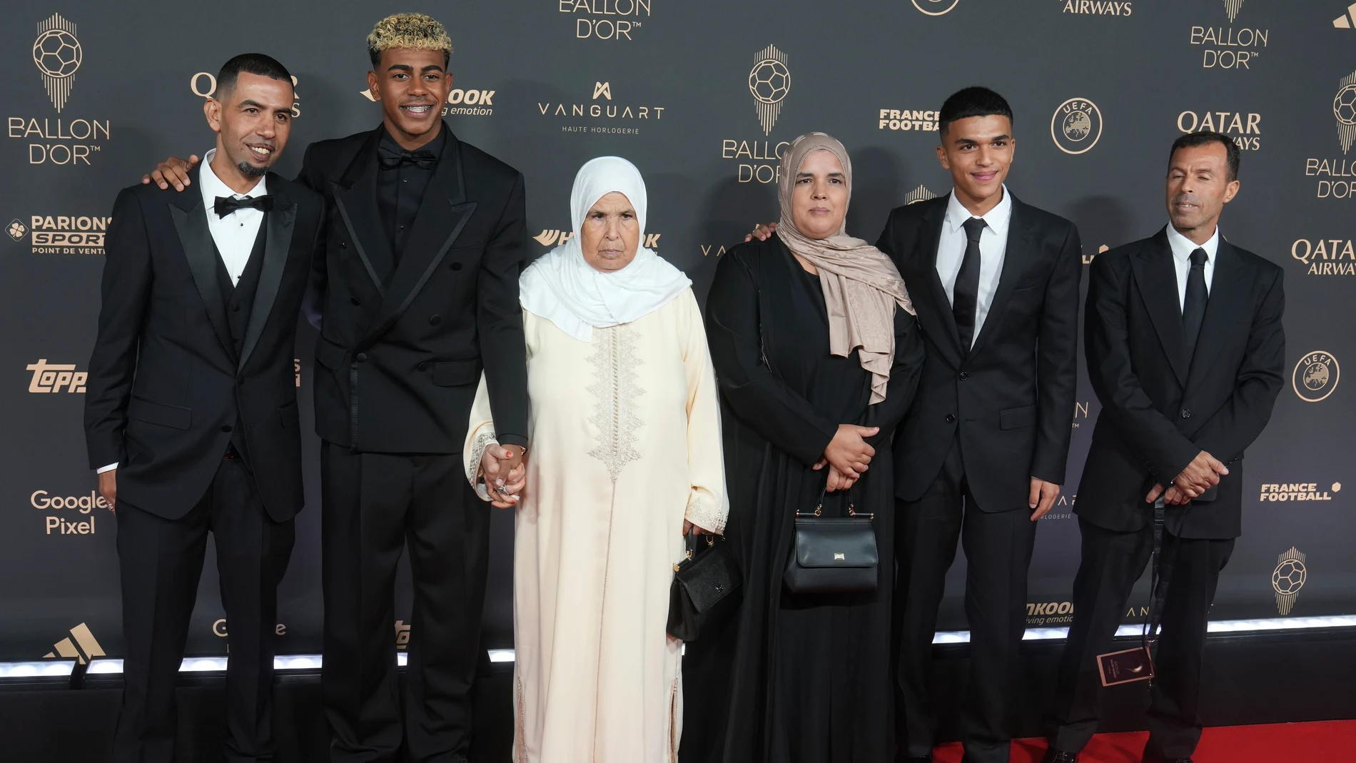 Barcelona's Lamine Yamal poses with members of his family as he arrives for the 69th Ballon d'Or (Golden Ball) award ceremony at Theatre du Chatelet in Paris, Monday, Sept. 22, 2025. (AP Photo/Thibault Camus)