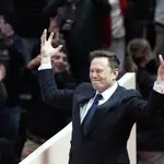 Elon Musk arrives on stage to speak at an indoor Presidential Inauguration parade event in Washington, Monday, Jan. 20, 2025. (AP Photo/Susan Walsh)