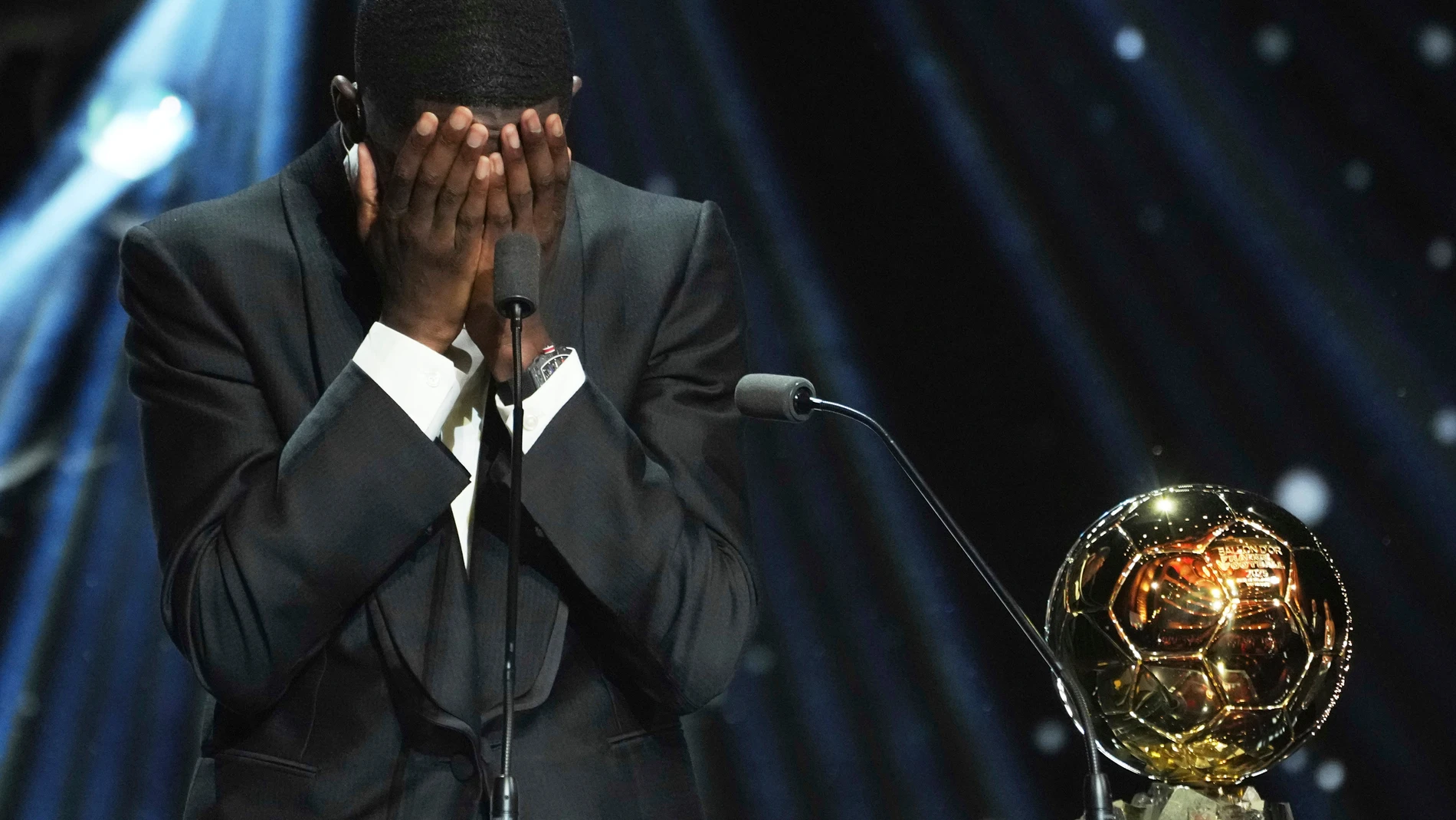 FILE - Paris Saint-Germain's Ousmane Dembélé reacts as he receives the 2025 Men's Ballon d'Or during the 69th Ballon d'Or awards ceremony at the Theatre du Chatelet in Paris, Monday, Sept. 22, 2025. (AP Photo/Thibault Camus)