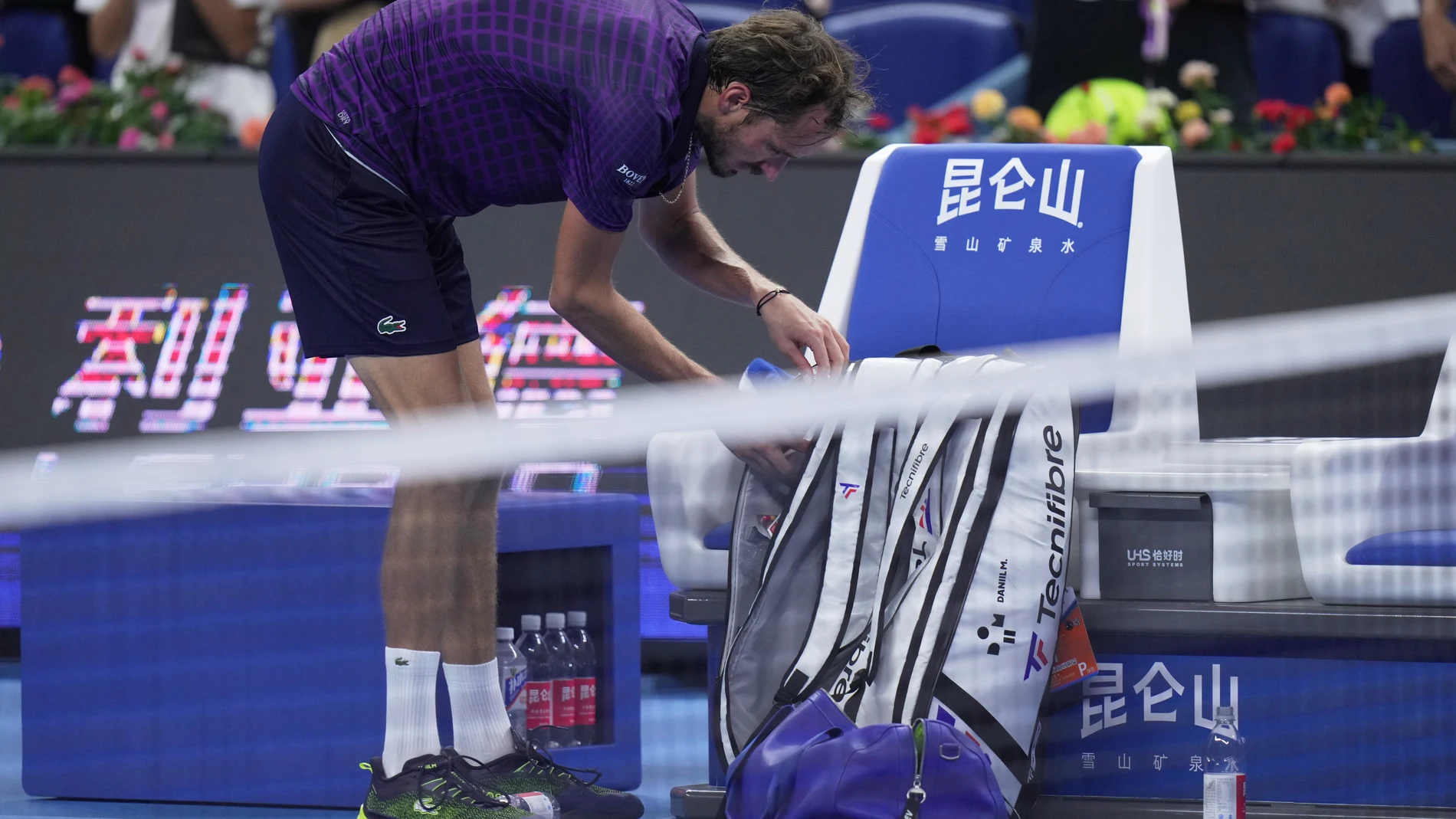 Daniil Medvedev, of Russia packs his bag after he retired from the men's singles semifinals match against Learner Tien, of the United States, in the China Open tennis tournament, in Beijing, Tuesday, Sept. 30, 2025. (AP Photo/Andy Wong)