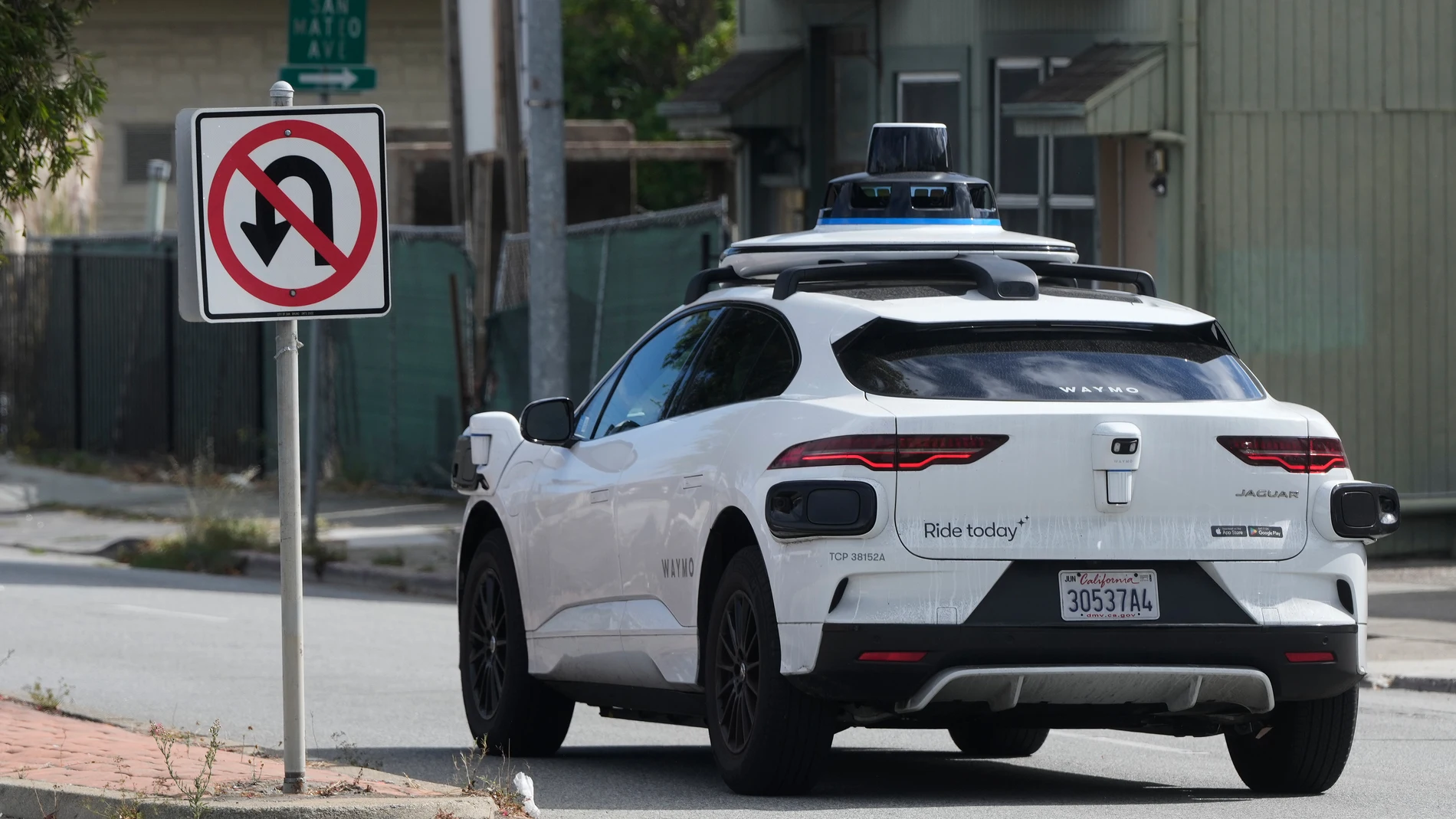 A Waymo vehicle drives past a No U-Turn sign in San Bruno, Calif., Tuesday, Sept. 30, 2025. (AP Photo/Jeff Chiu)
