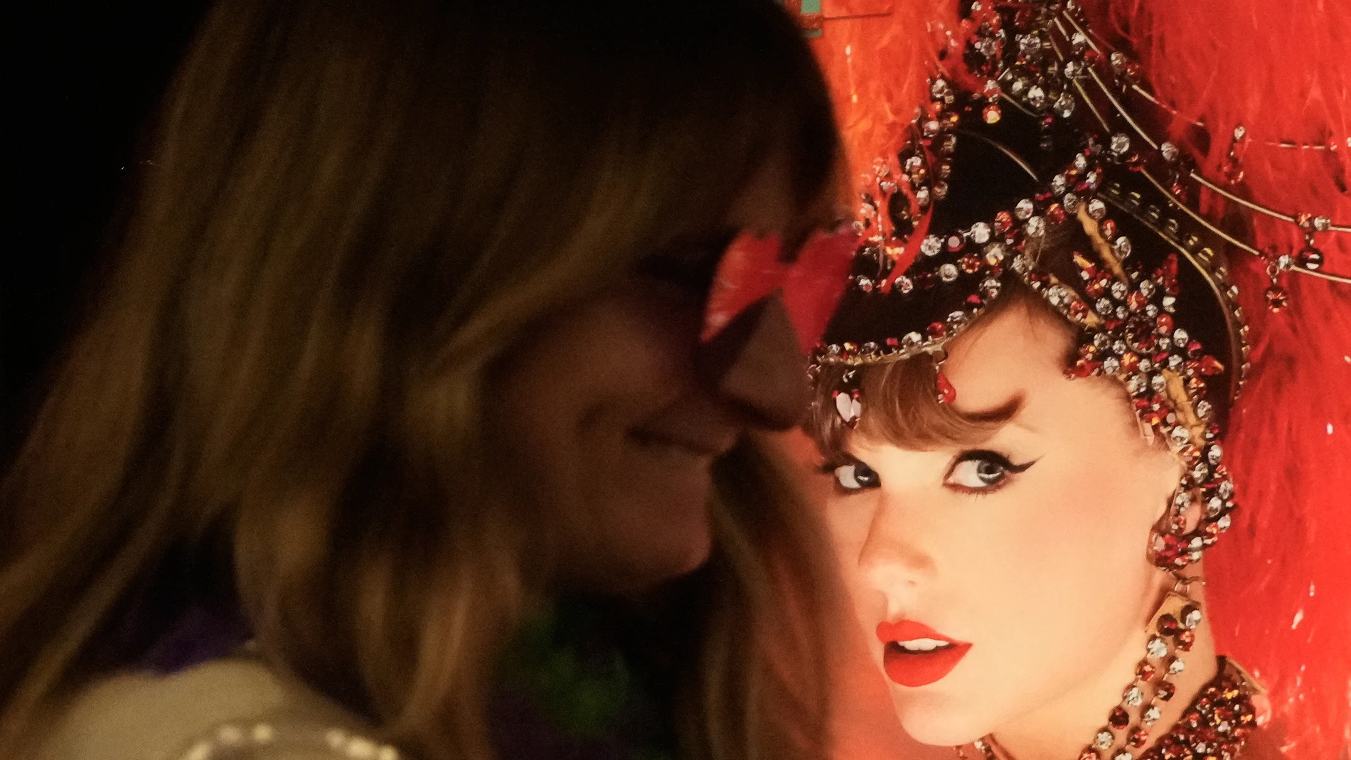 Jenni Boyer stands near a poster of Taylor Swift before the official release of Swift's new album, "The Life of a Showgirl," at the AMC Metreon in San Francisco, Friday, Oct. 3, 2025. (AP Photo/Jeff Chiu)