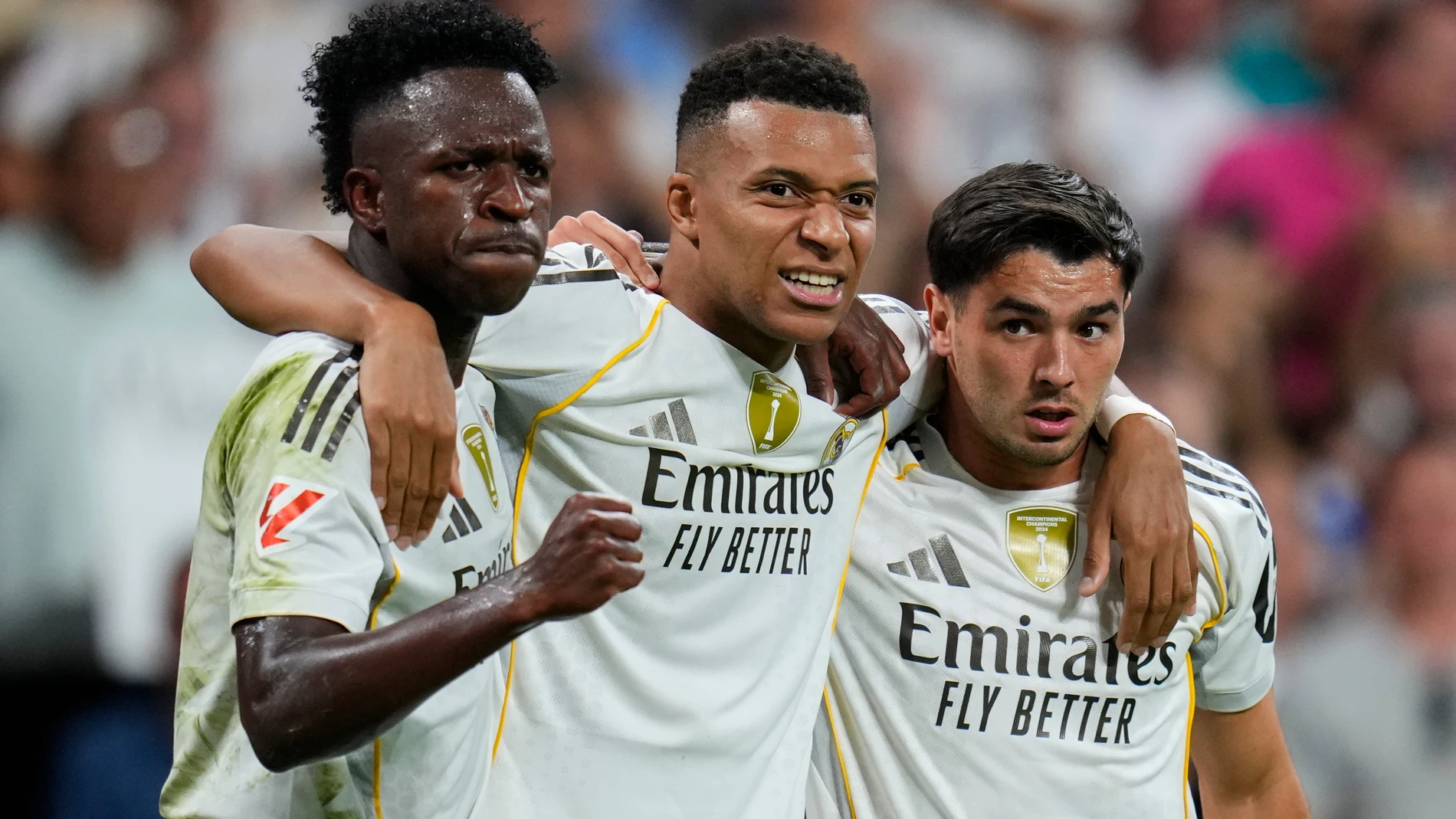 Real Madrid's Kylian Mbappe, centre, celebrates with Vinicius Junior, left, and Brahim Diaz after scoring his side's third goal during the Spanish La Liga soccer match between Real Madrid and Villarreal at the Santiago Bernabeu stadium in Madrid, Spain, Saturday, Oct. 4, 2025. (AP Photo/Manu Fernandez)