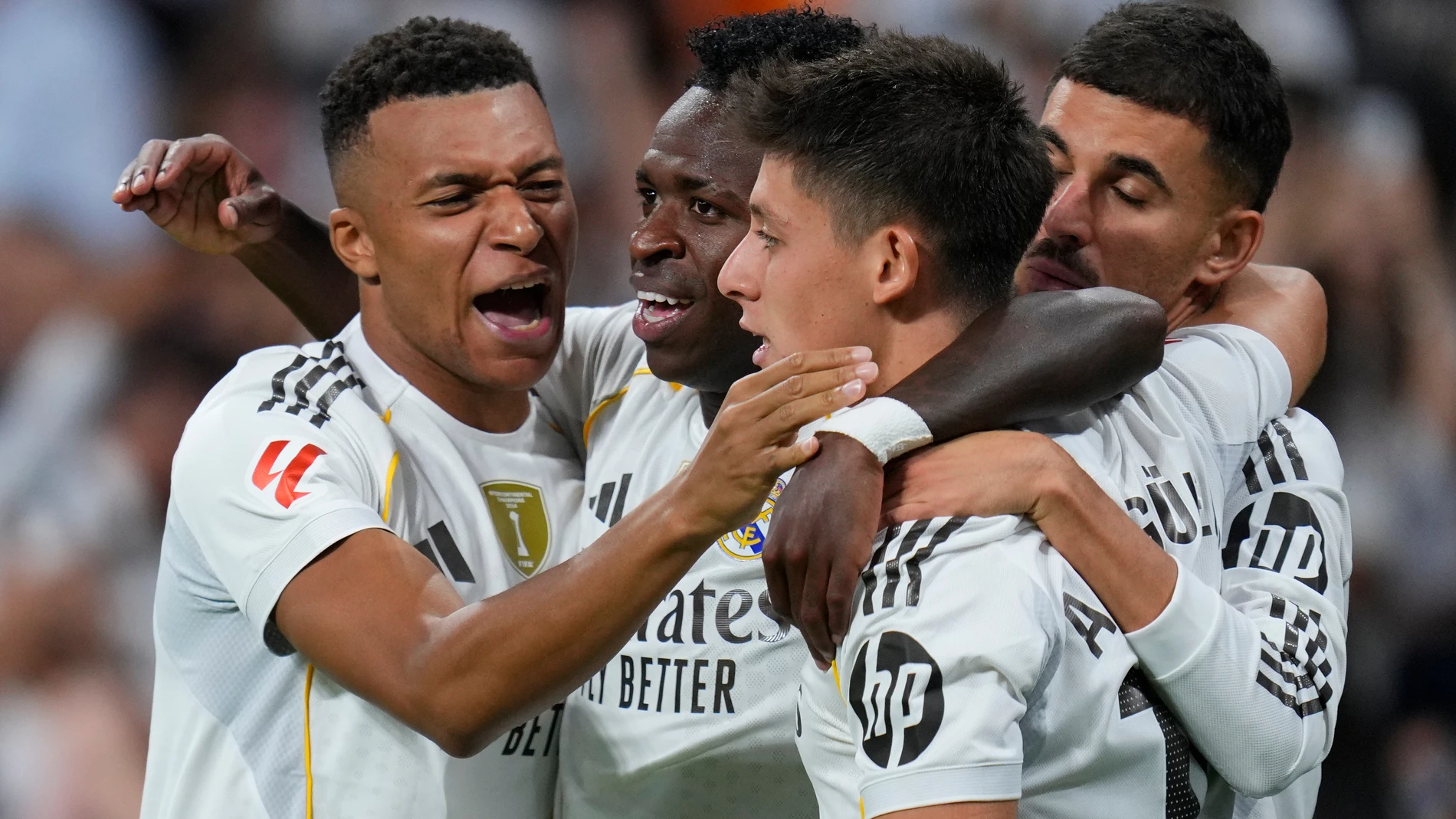 Real Madrid's Vinicius Junior, second from left, celebrates with Kylian Mbappe, left, Dani Ceballos, right, and Arda Guler after scoring the opening goal during the Spanish La Liga soccer match between Real Madrid and Villarreal at the Santiago Bernabeu stadium in Madrid, Spain, Saturday, Oct. 4, 2025. (AP Photo/Manu Fernandez)