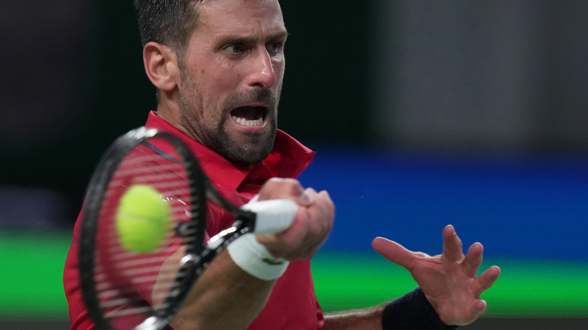 Novak Djokovic of Serbia returns a forehand shot from Jaume Munar of Spain during the men's singles match of the Shanghai Masters tennis tournament at Qizhong Forest Sports City Tennis Center, in Shanghai, China, Tuesday, Oct. 7, 2025. (AP Photo/Andy Wong)