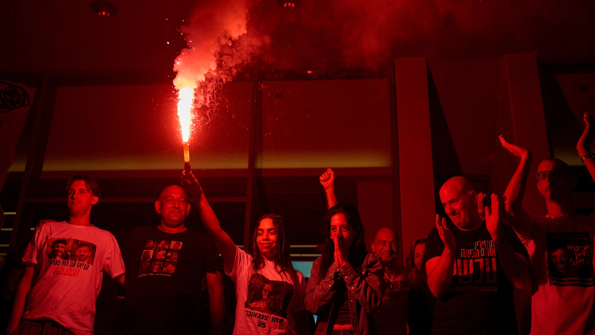 Einav Zangauker, center, mother of Matan Zangauker, who is being held hostage by Hamas, celebrate along with other families and supporters of Israeli hostages after the announcement that Israel and Hamas have agreed to the first phase of a peace plan, as they gather at a plaza known as the hostages square in Tel Aviv, Israel, Thursday, Oct. 9, 2025. (AP Photo/Ohad Zwigenberg)