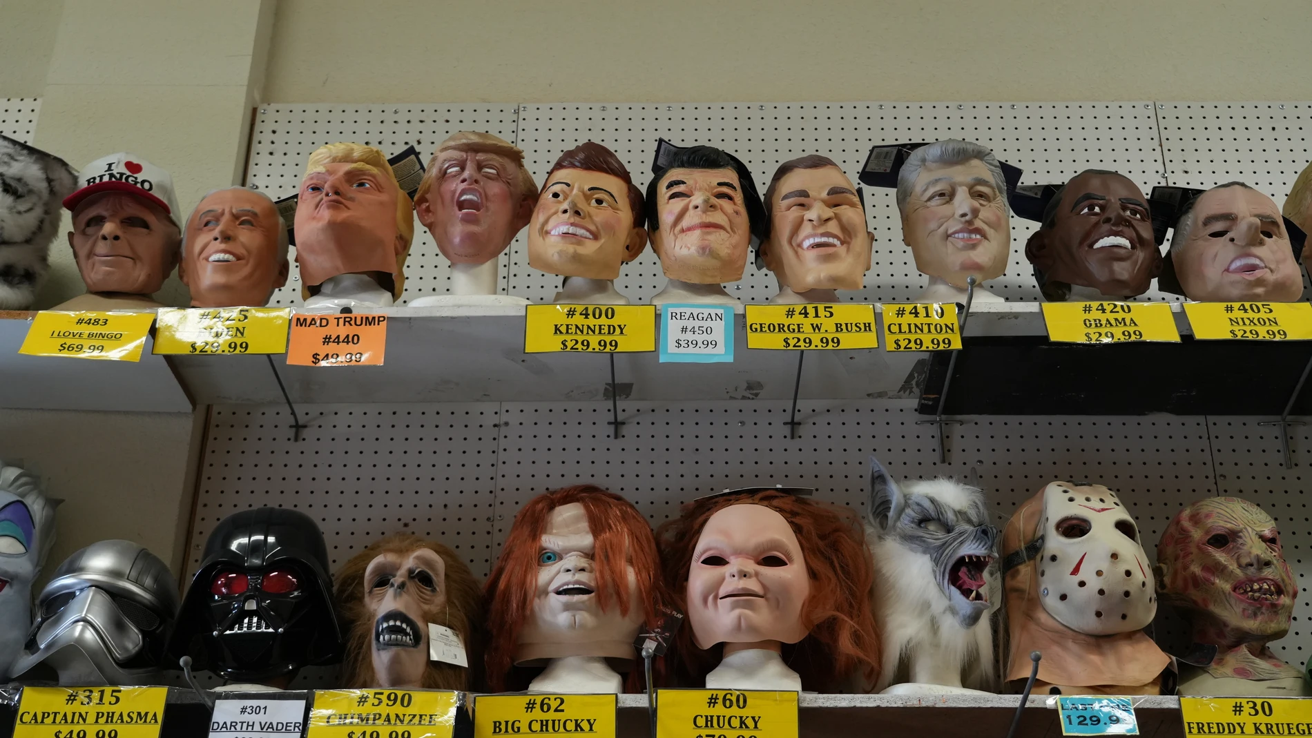 A variety of face masks line the shelves at the House of Humor costume shop in Redwood City, Calif., Thursday, Sept. 18, 2025. (AP Photo/Terry Chea)
