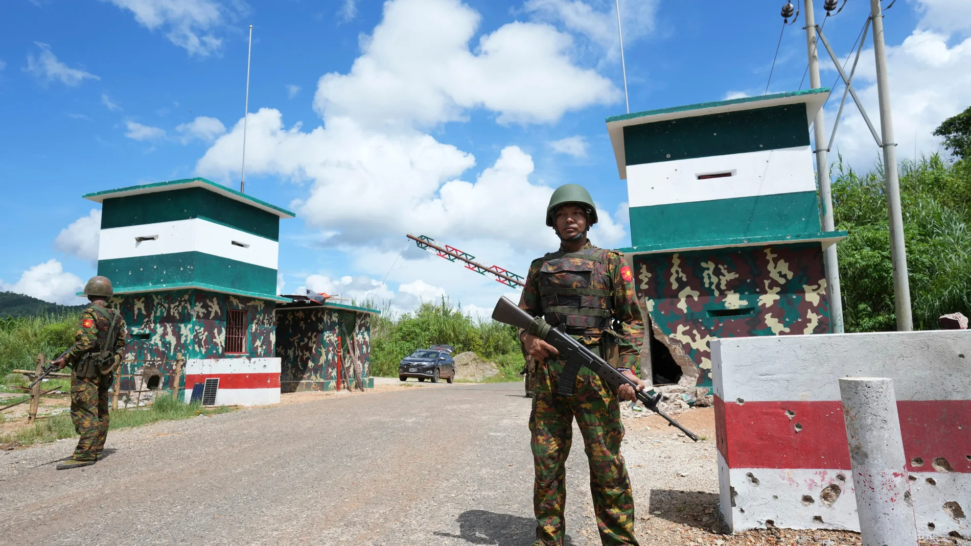 In this photo taken during a trip supervised by pro-military Myanmar media, soldiers stand guard at a check point in Kyaukme, northern Shan State, Myanmar, Friday, Oct. 10, 2025. (AP Photo/Aung Shine Oo)